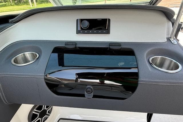 Dashboard of 2026 Regal LS4 boat with cup holders and audio system.