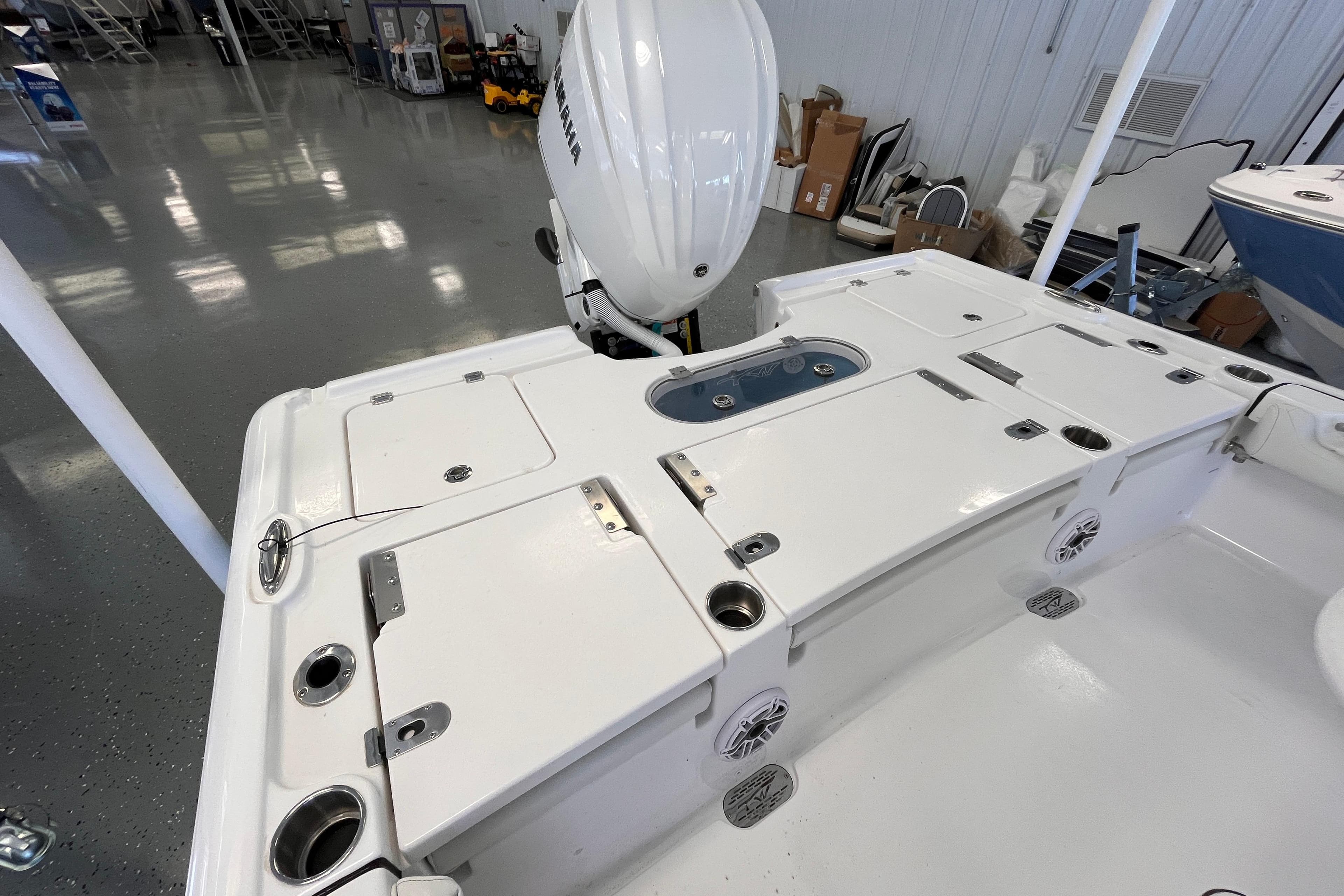 2026 Tidewater 2500 Carolina Bay boat deck with storage compartments and Yamaha engine.