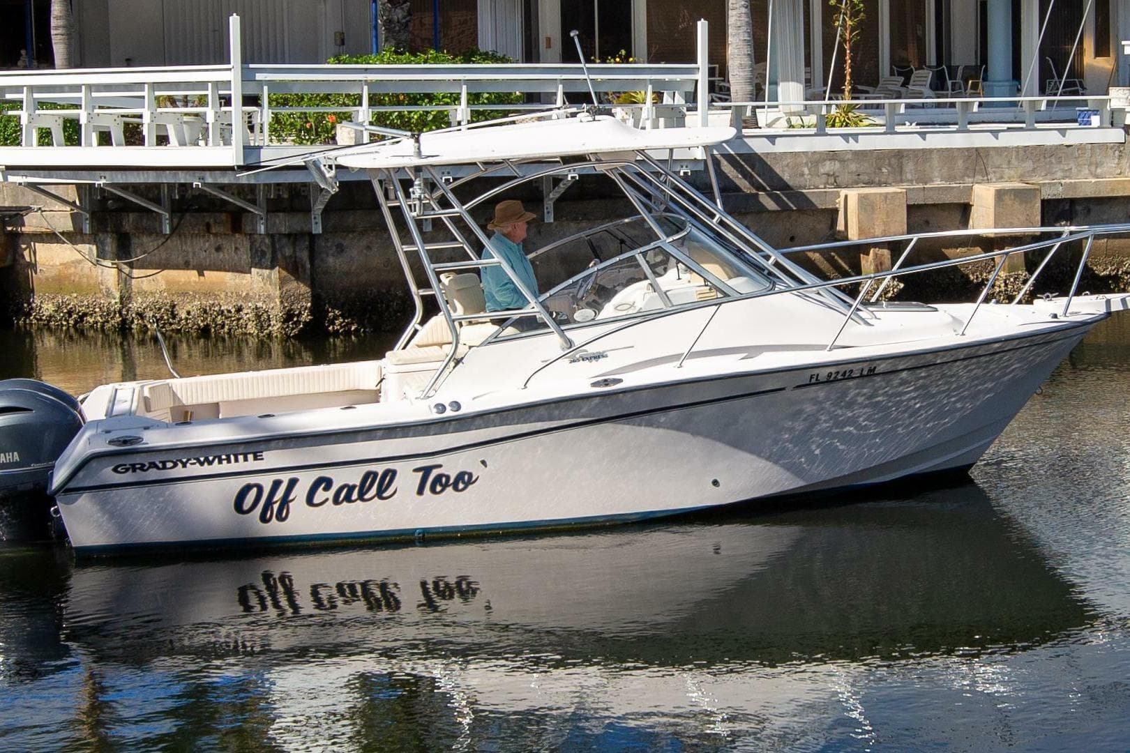 2001 Grady-White Express 265 boat docked on calm water.