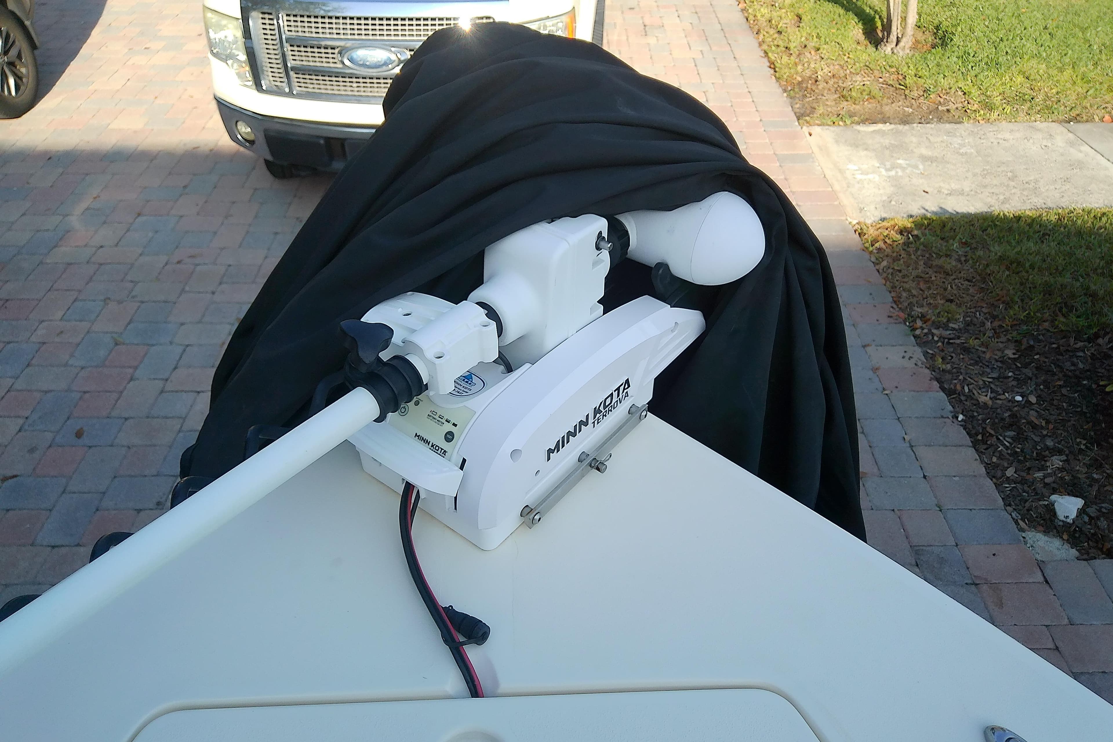 2018 Scout 251 XSS boat with Minn Kota trolling motor on a driveway.