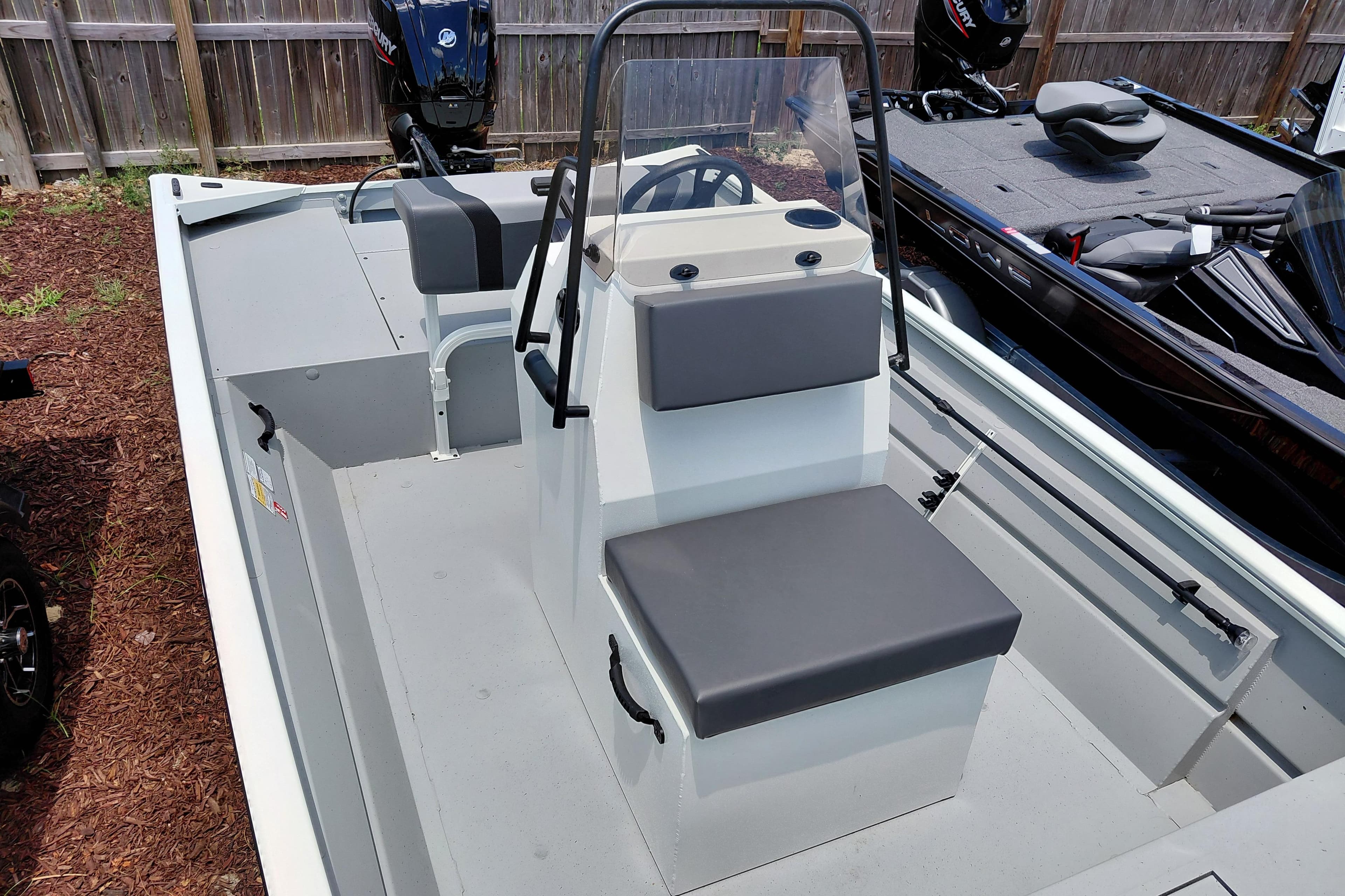 2026 Lowe Roughneck RX1860 CC boat with center console and seating, displayed outdoors.