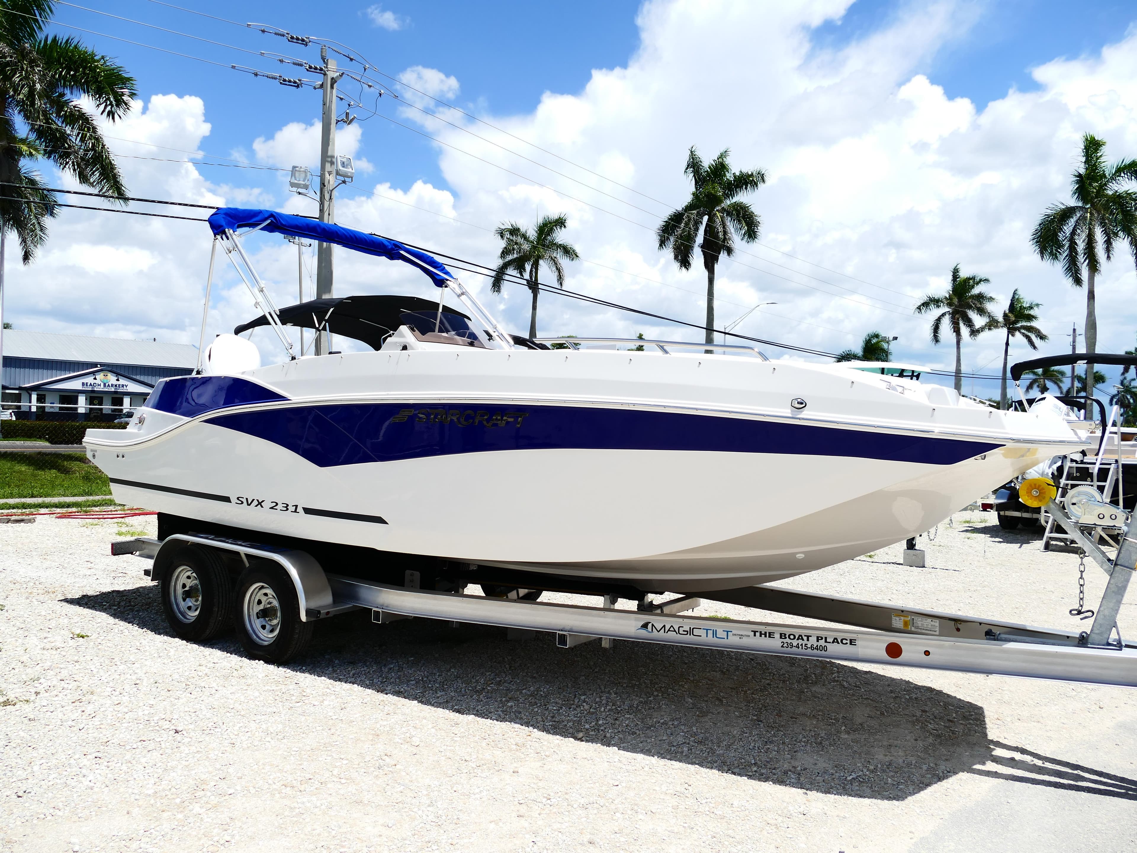 2026 Starcraft SVX 231 OB DH boat on trailer, parked outdoors under blue sky.