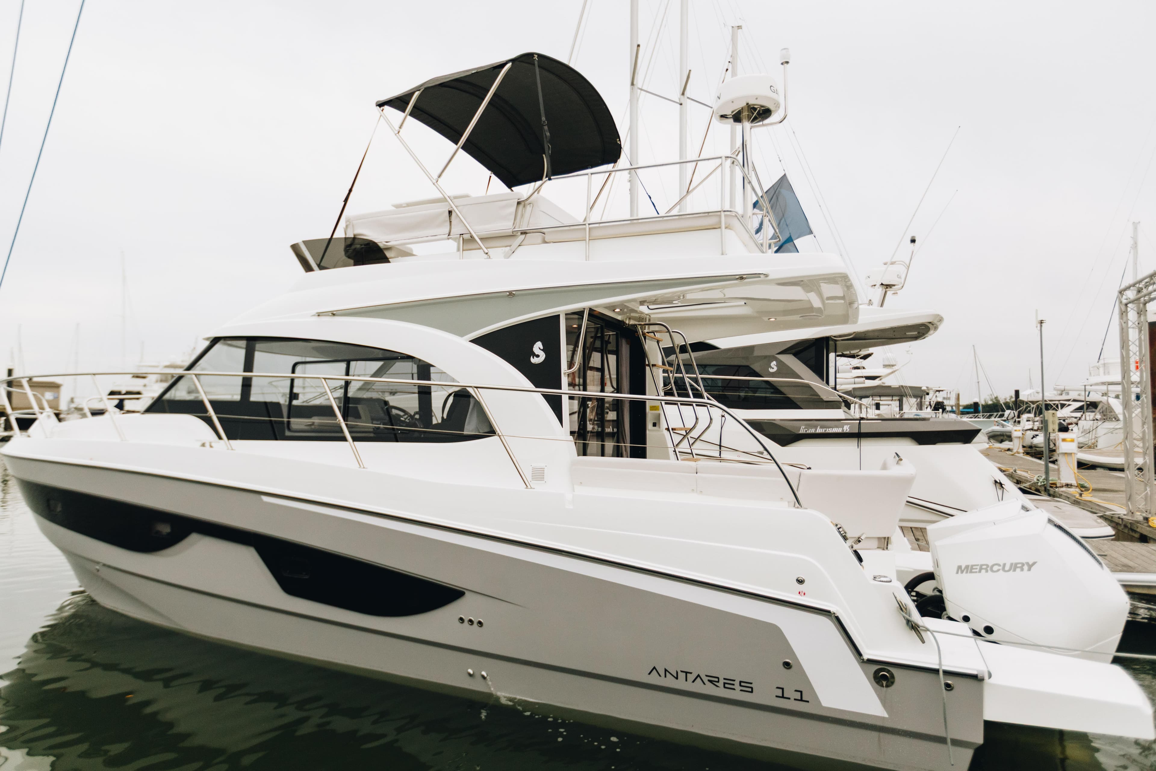 2026 Beneteau Antares 11 Fly yacht docked at marina, side view.
