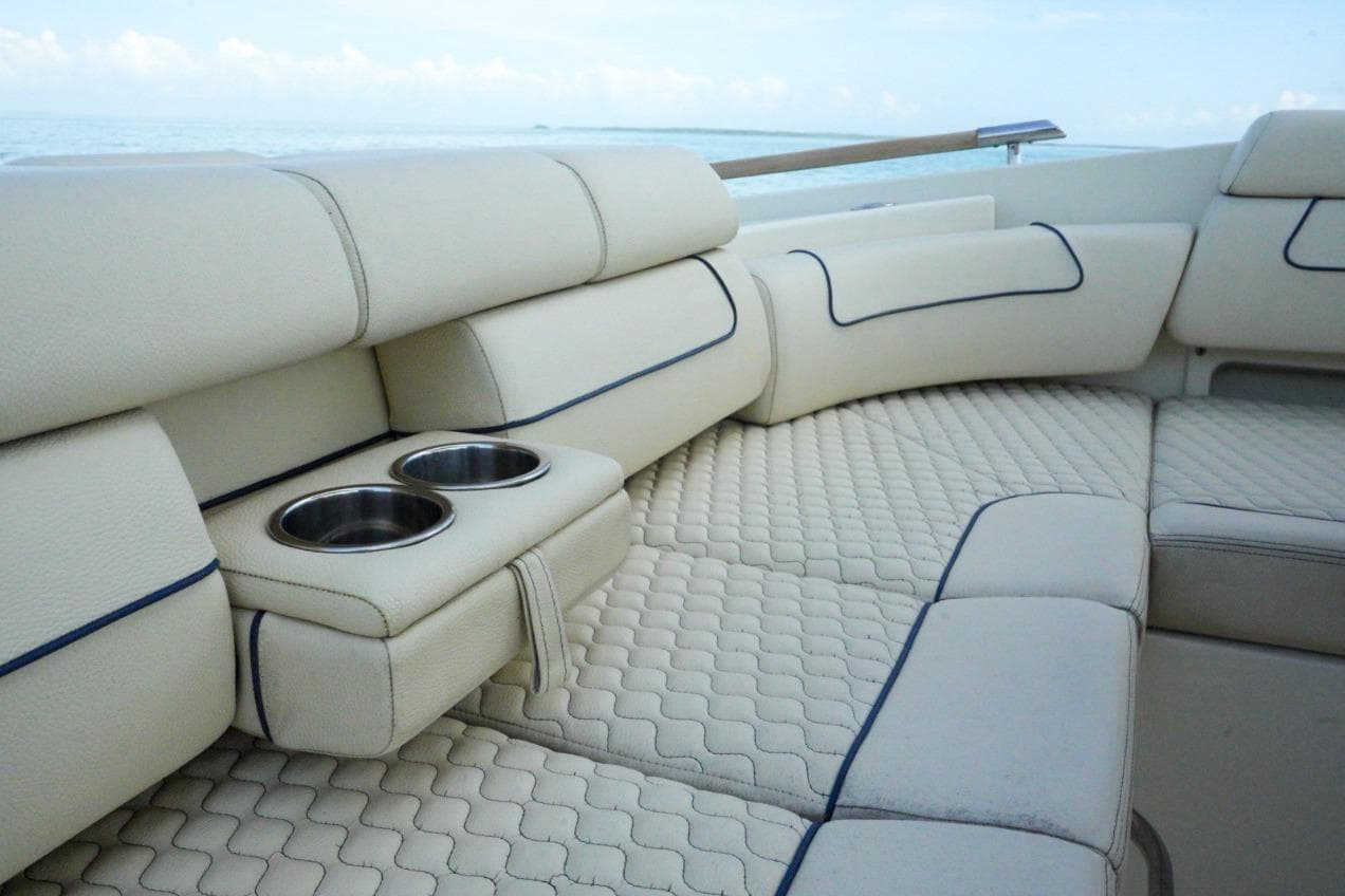 Luxurious seating on 2019 Chris-Craft Launch 35 GT OB with cup holders, ocean view.