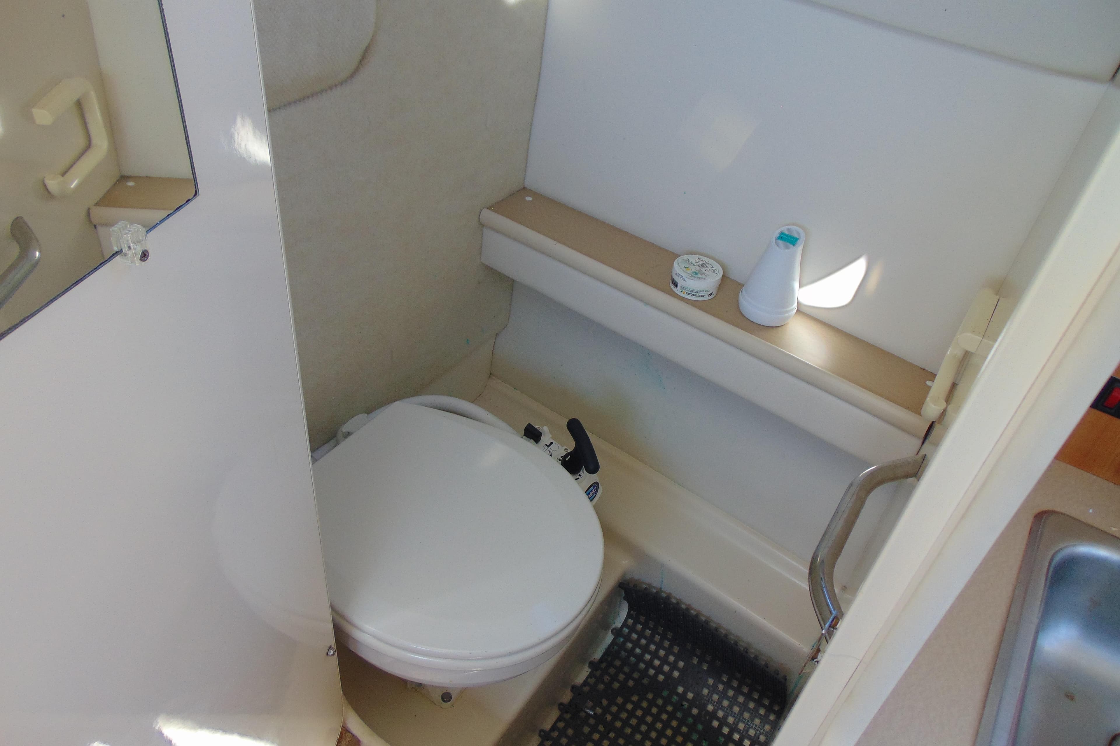 2002 Bayliner 2452 Ciera Classic boat bathroom with toilet and shelf.