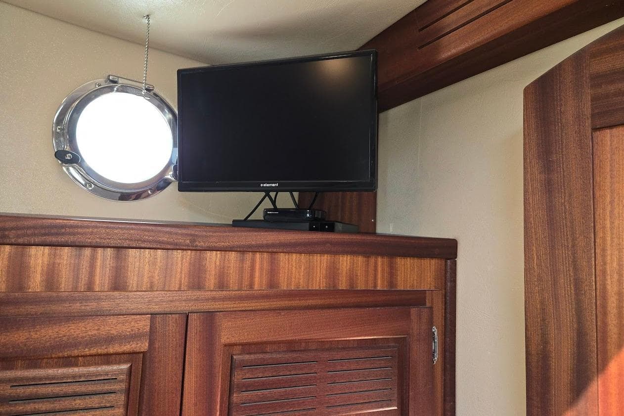 TV and porthole in 2010 American Tug "34" Pilothouse Trawler interior.
