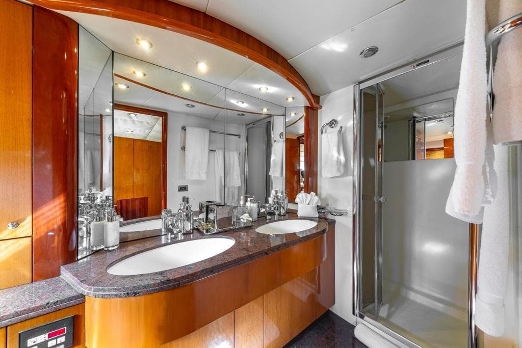 Luxurious bathroom on 2003 Sunseeker 82 Yacht with double sinks and modern shower.