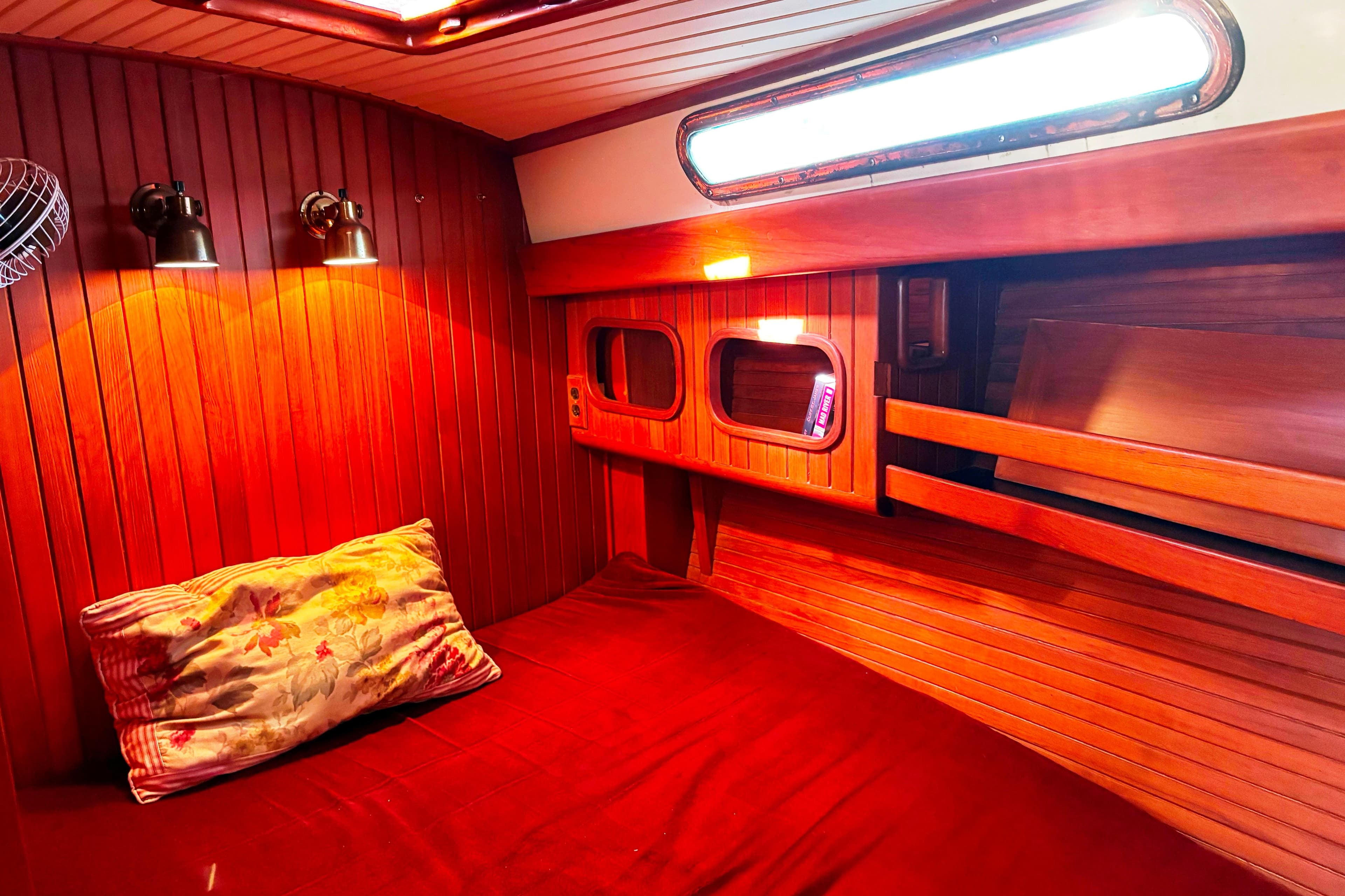 Cozy cabin interior of 1987 Hans Christian Cristina 40 sailboat with warm wood paneling.