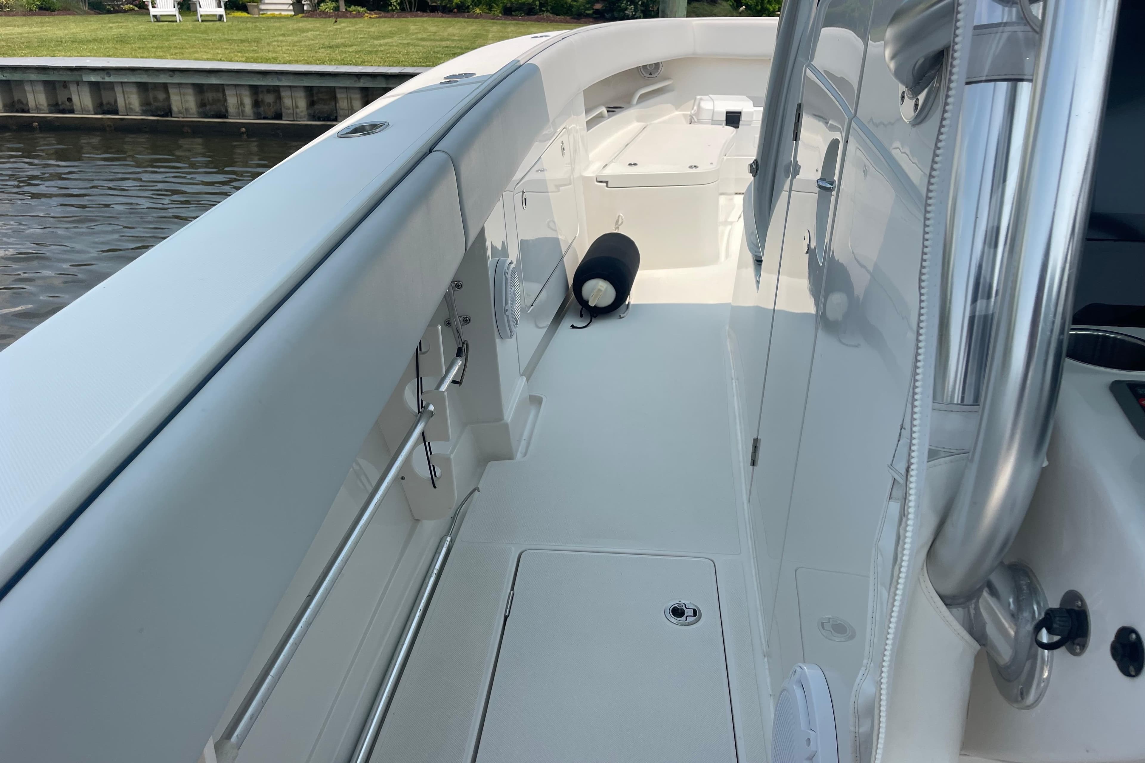 2020 Jupiter 38 boat deck, sleek design, docked by calm waters.
