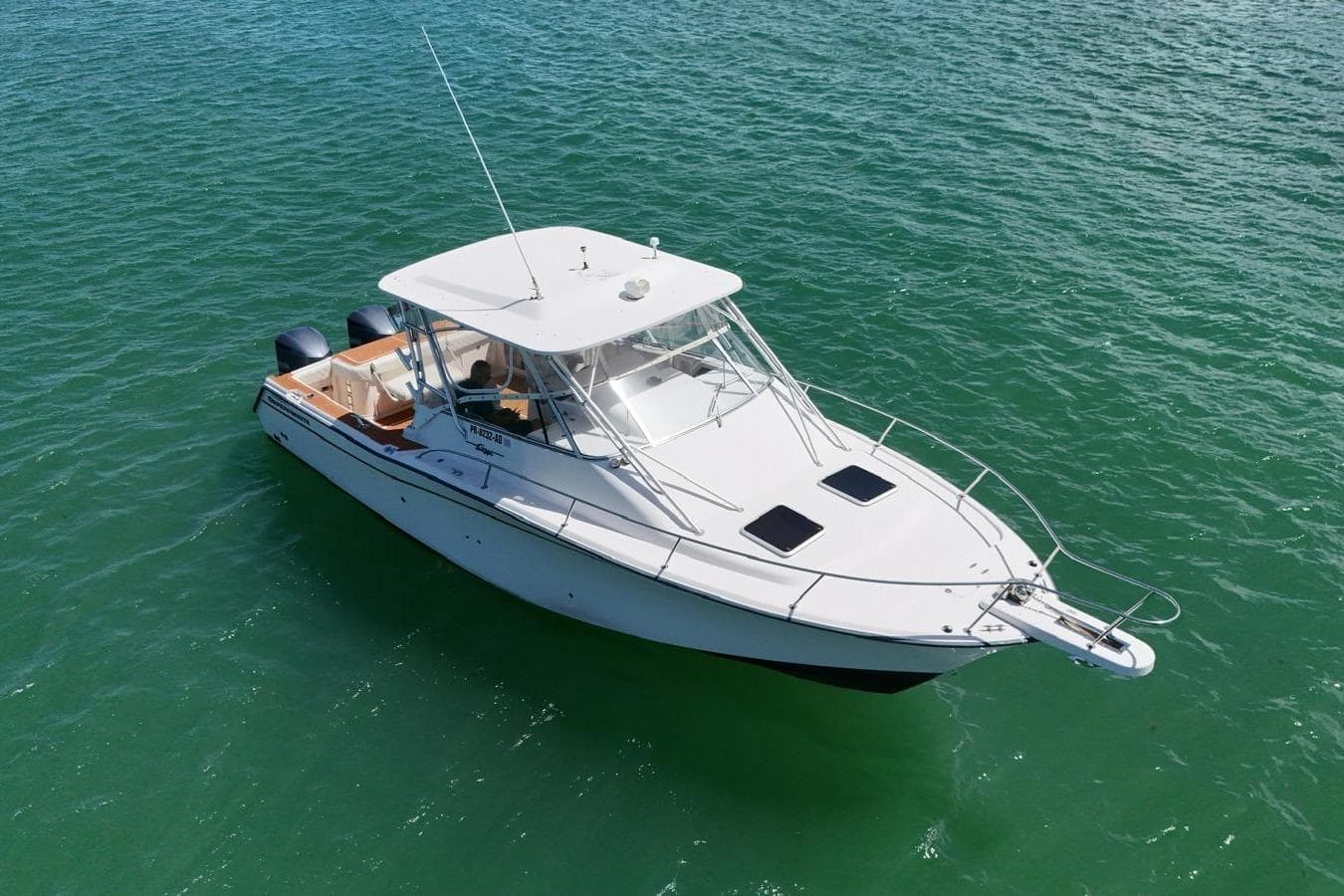 2004 Grady-White Express 330 boat cruising on clear green water.
