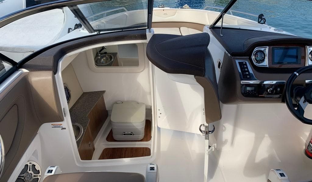 2014 Chaparral 257 SSX boat interior with helm, seating, and compact cabin area.