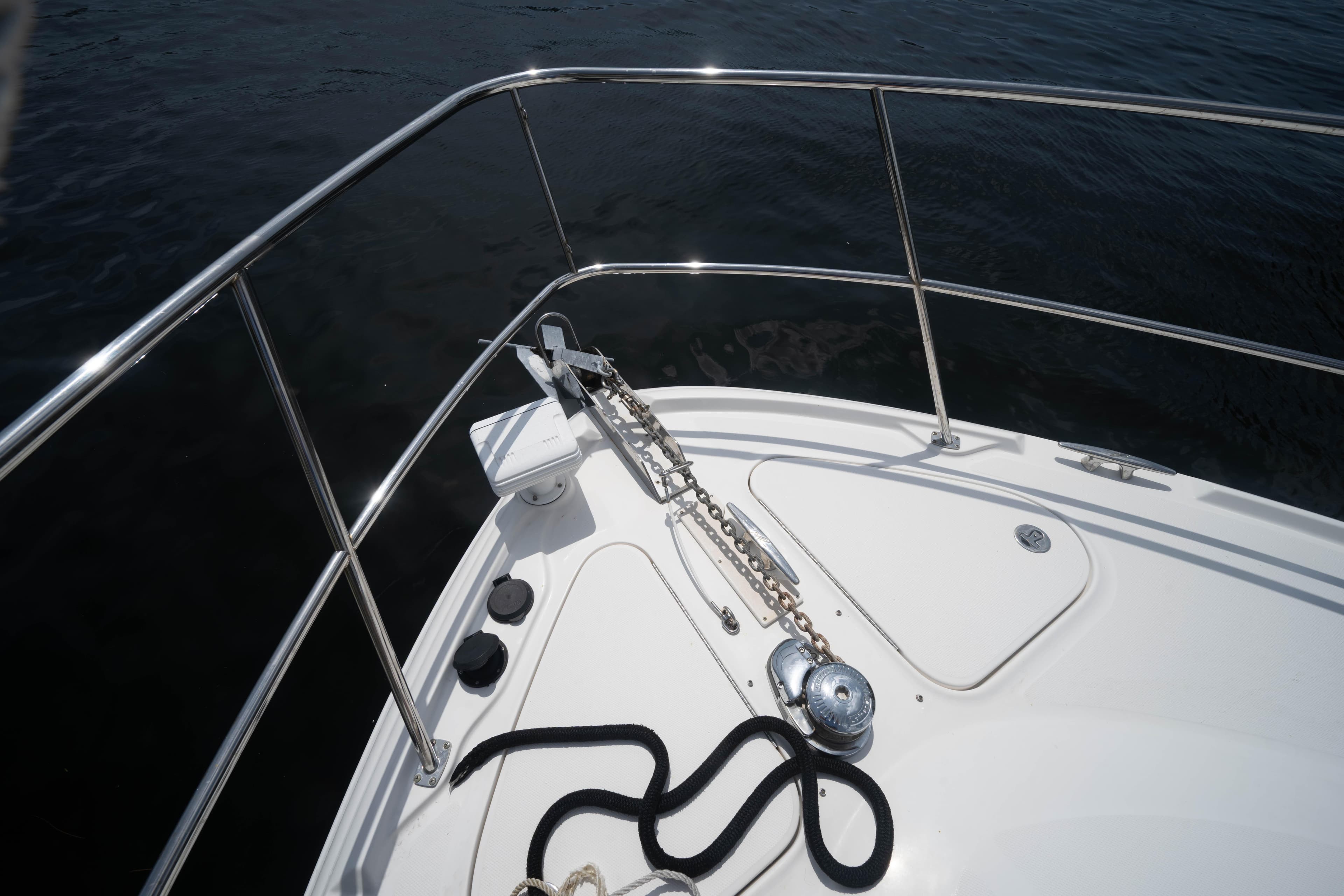Bow of 2006 Sea Ray 48 Sundancer with anchor chain and railing.