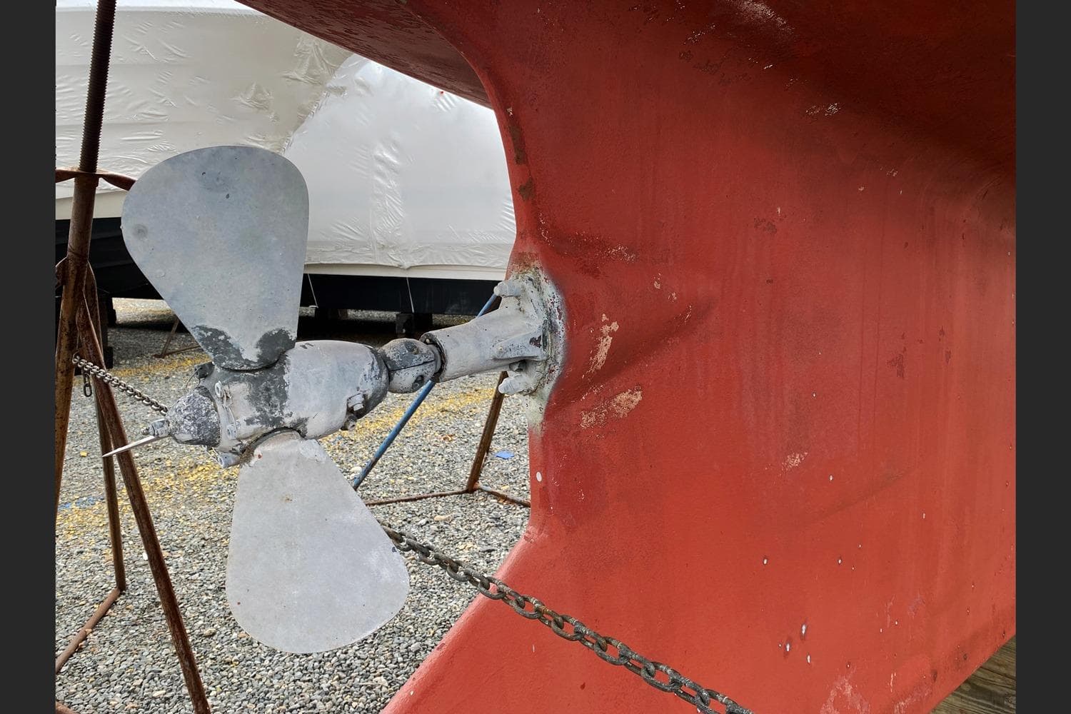 Propeller of 2005 Cabo Rico 42 Cutter sailboat on dry dock, showing wear and rust.