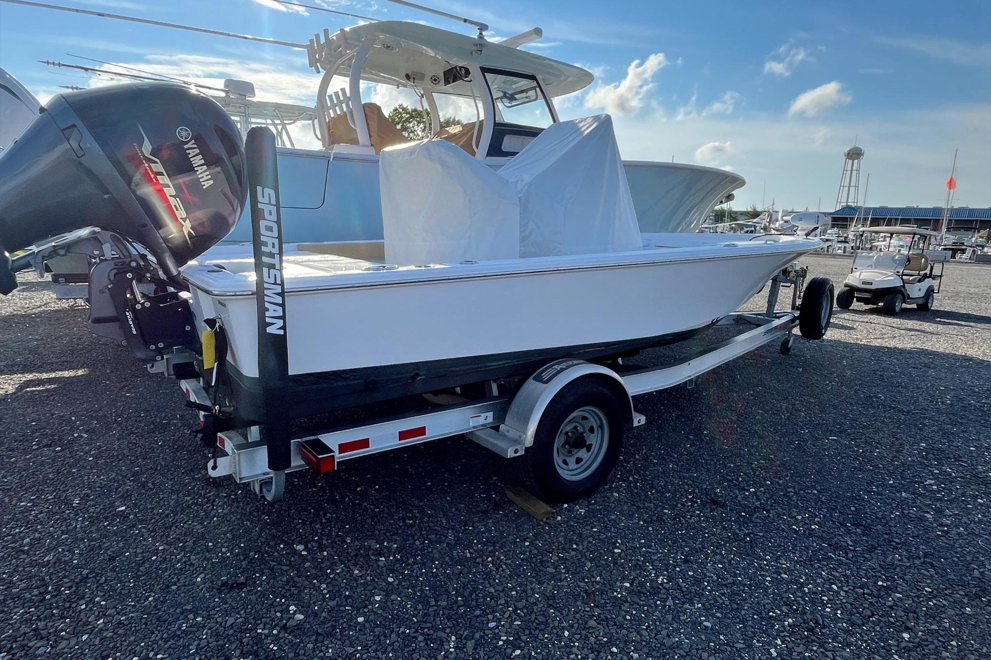2022 Sportsman Masters 207 Bay Boat on trailer, parked outdoors under clear sky.