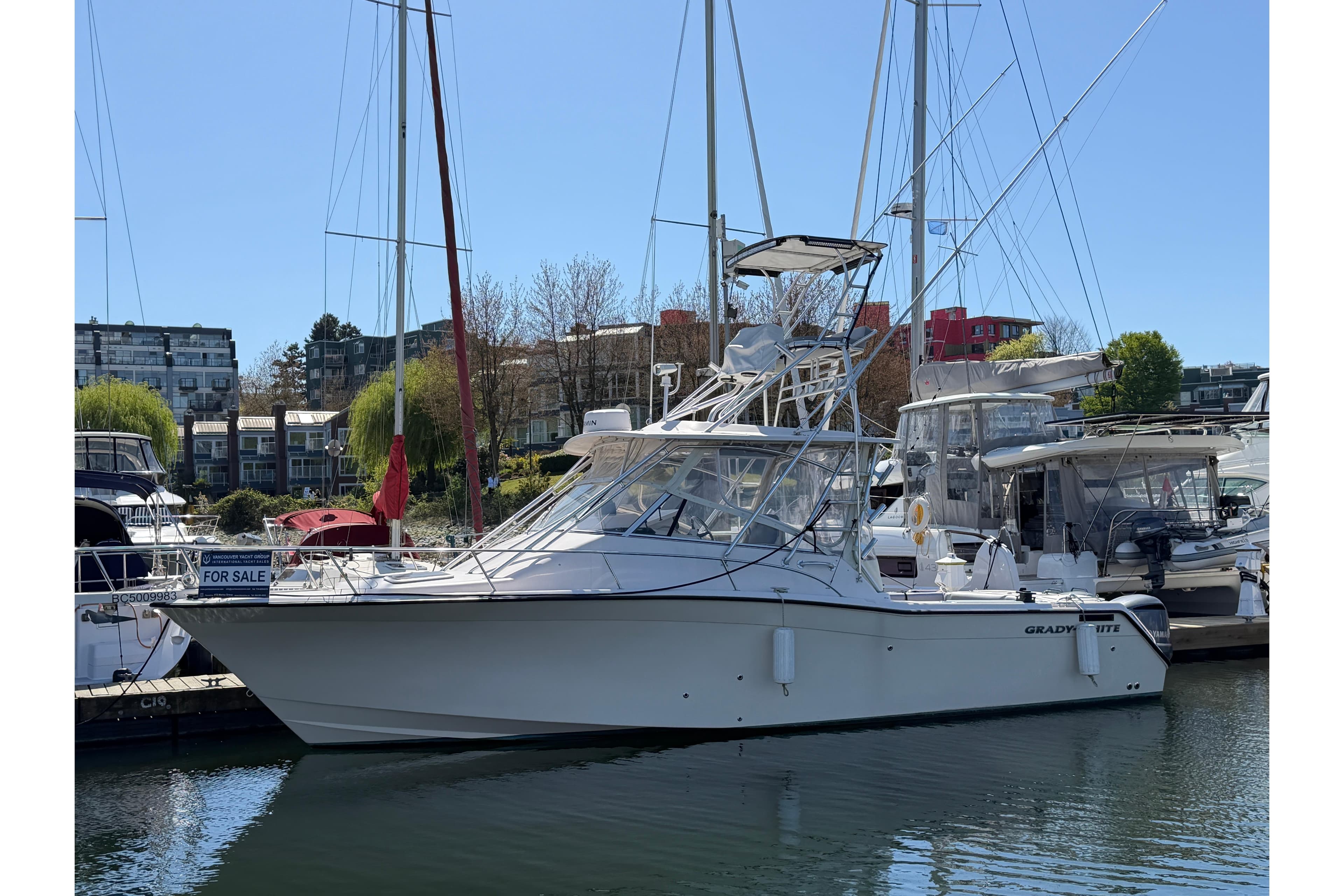 2004 Grady-White Express 330 boat docked, for sale, in a marina setting.