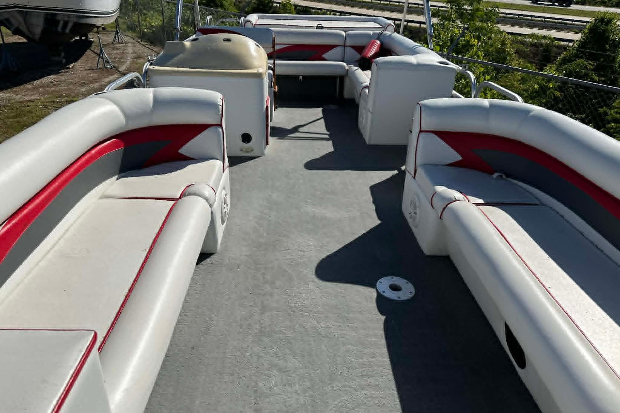 1999 PlayCraft Sport 2400 pontoon boat interior with red and white seating.