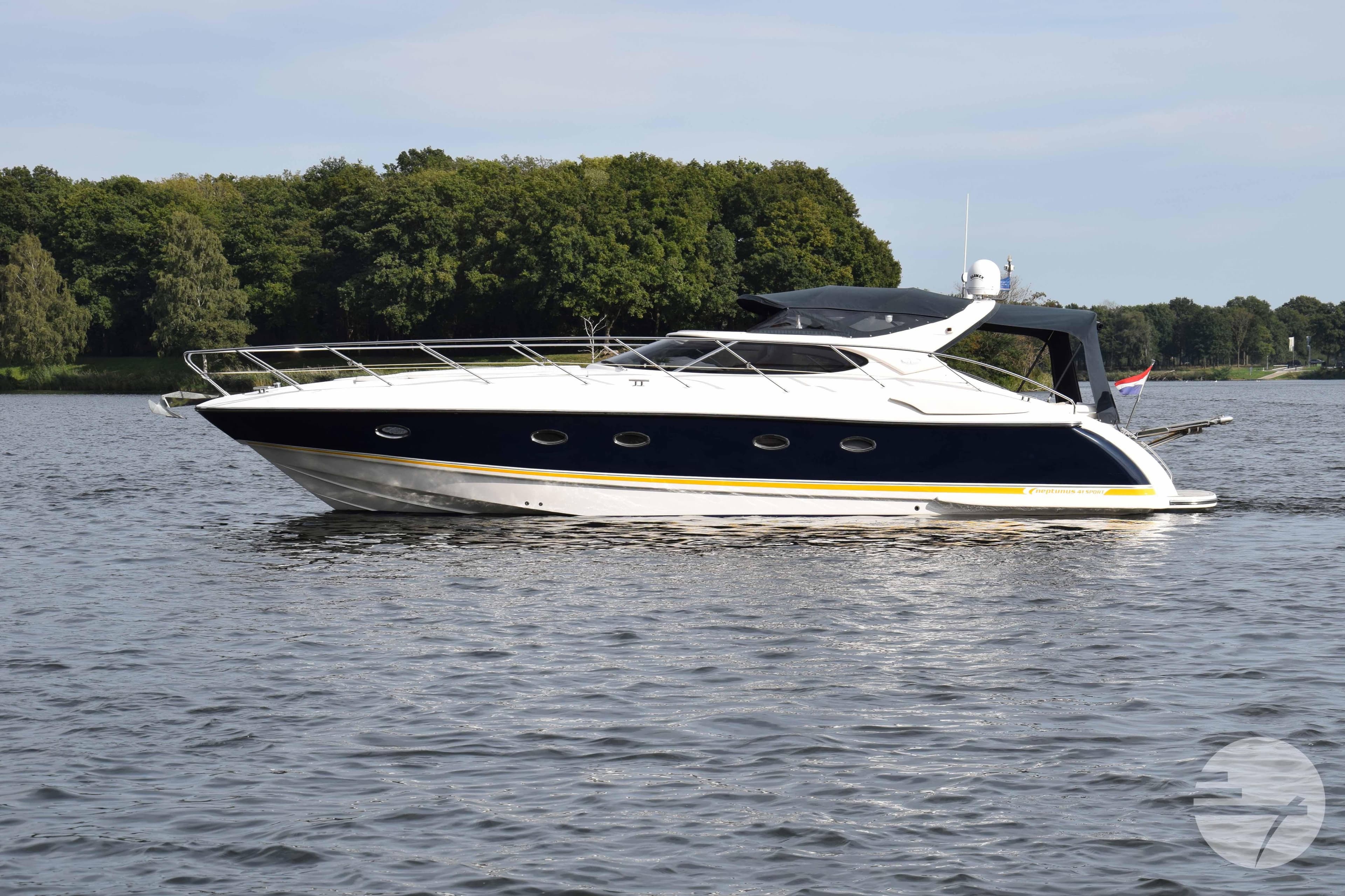 2004 Neptunus 41 Sport yacht on calm water, surrounded by lush greenery.