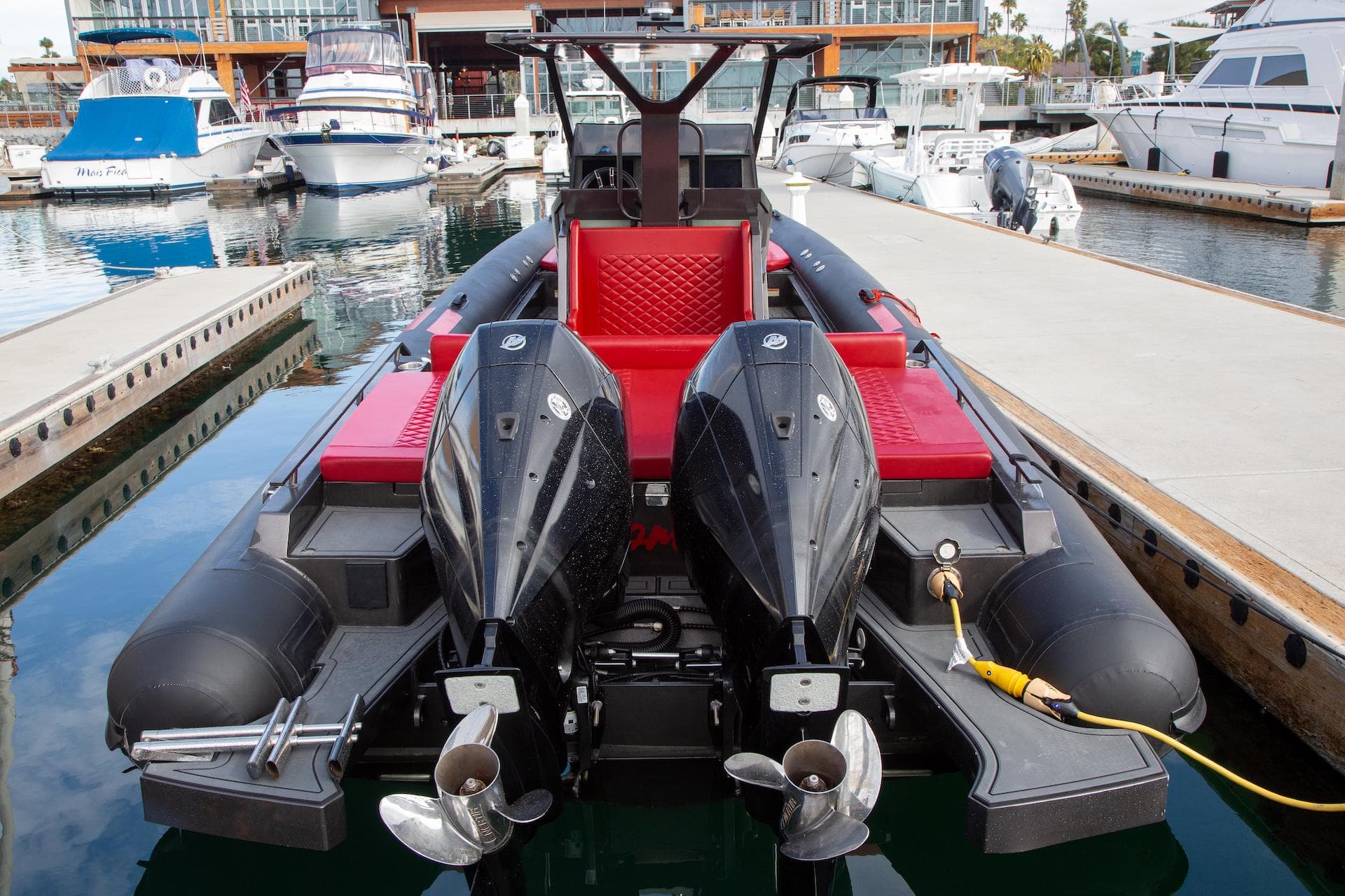 2023 Novielli Veloche 349 boat with dual engines docked at a marina.