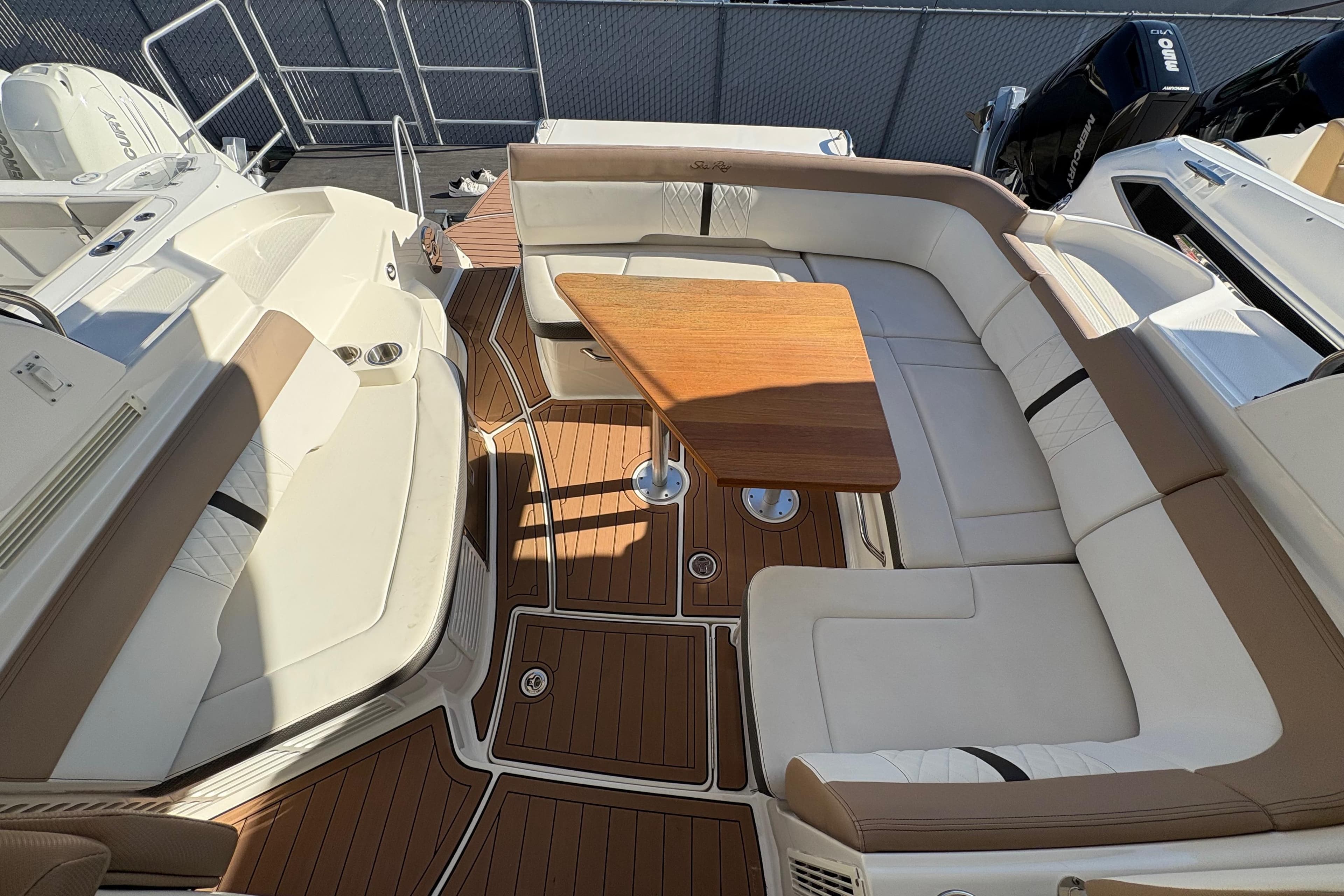 2018 Sea Ray Sundancer 350 Coupe interior with elegant seating and wooden table.