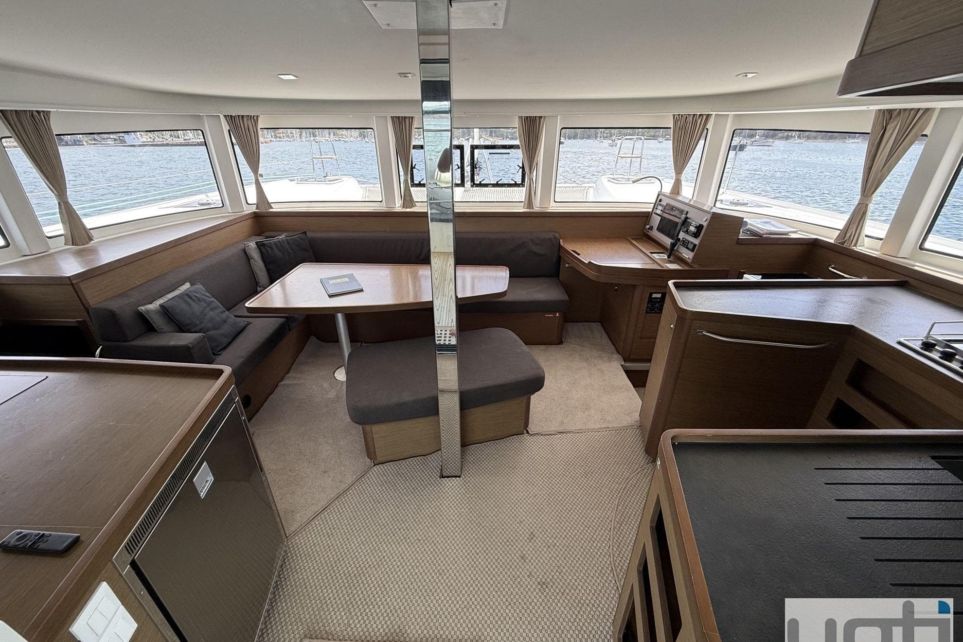 Interior of 2019 Lagoon 42 catamaran with modern seating, dining area, and panoramic windows.