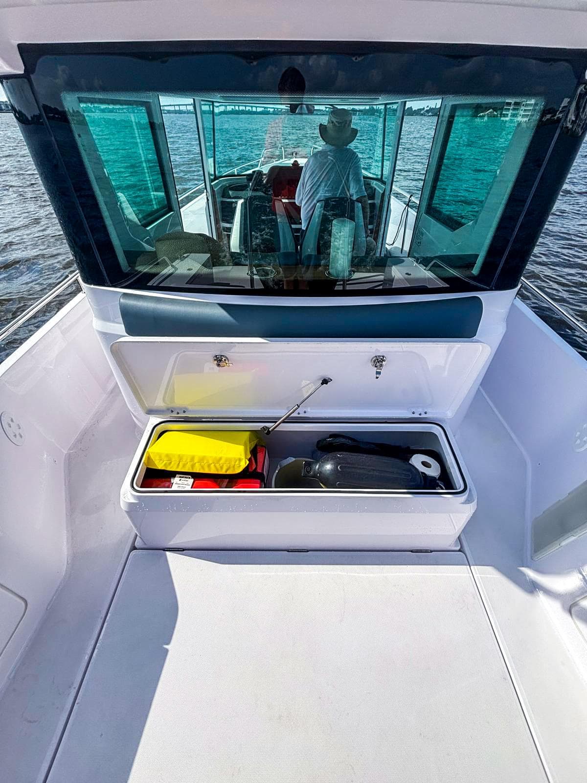 2022 Axopar 28 CABIN boat with open storage compartment on deck.