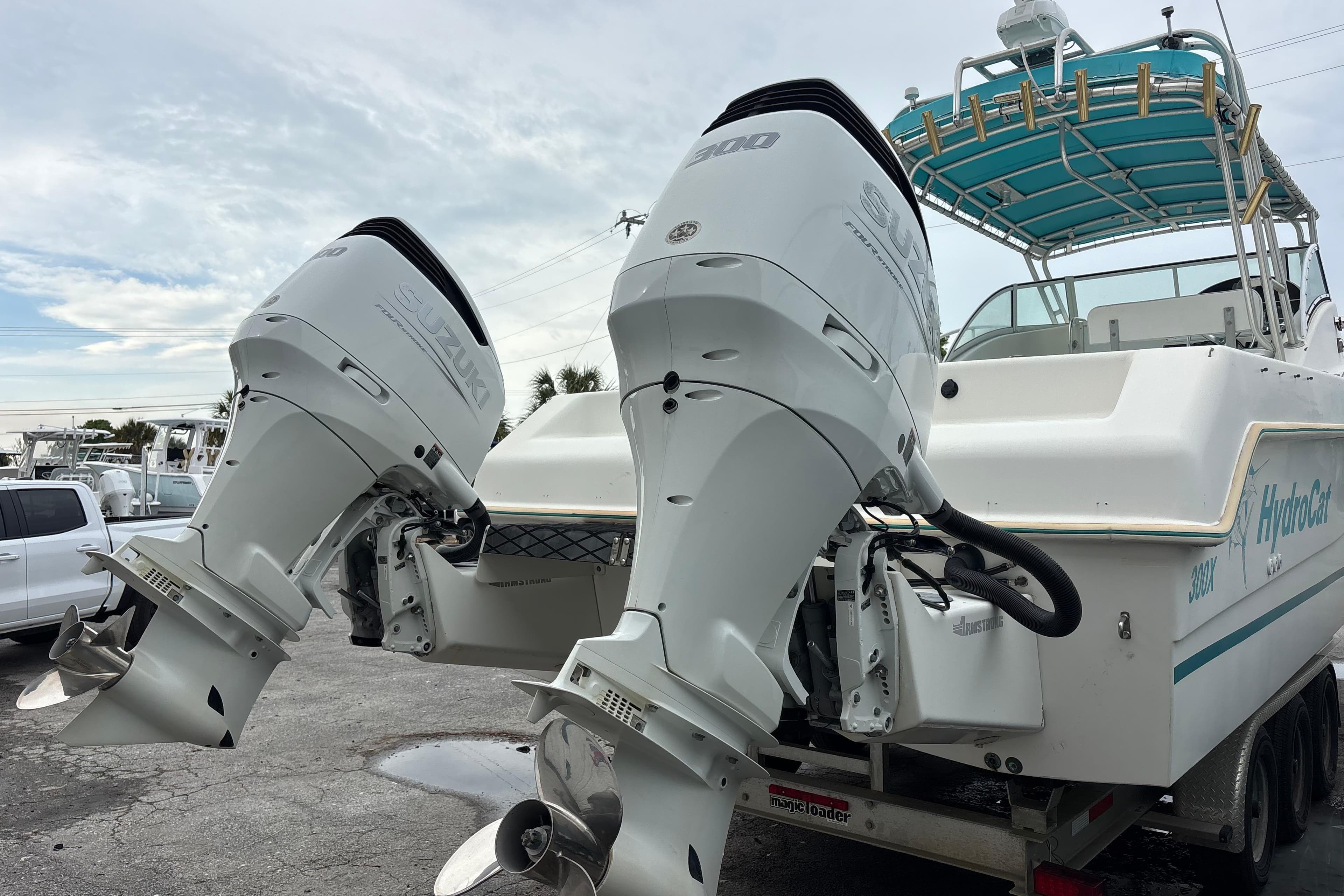 1998 Hydrocat 300X boat with dual Suzuki outboard motors on a trailer.
