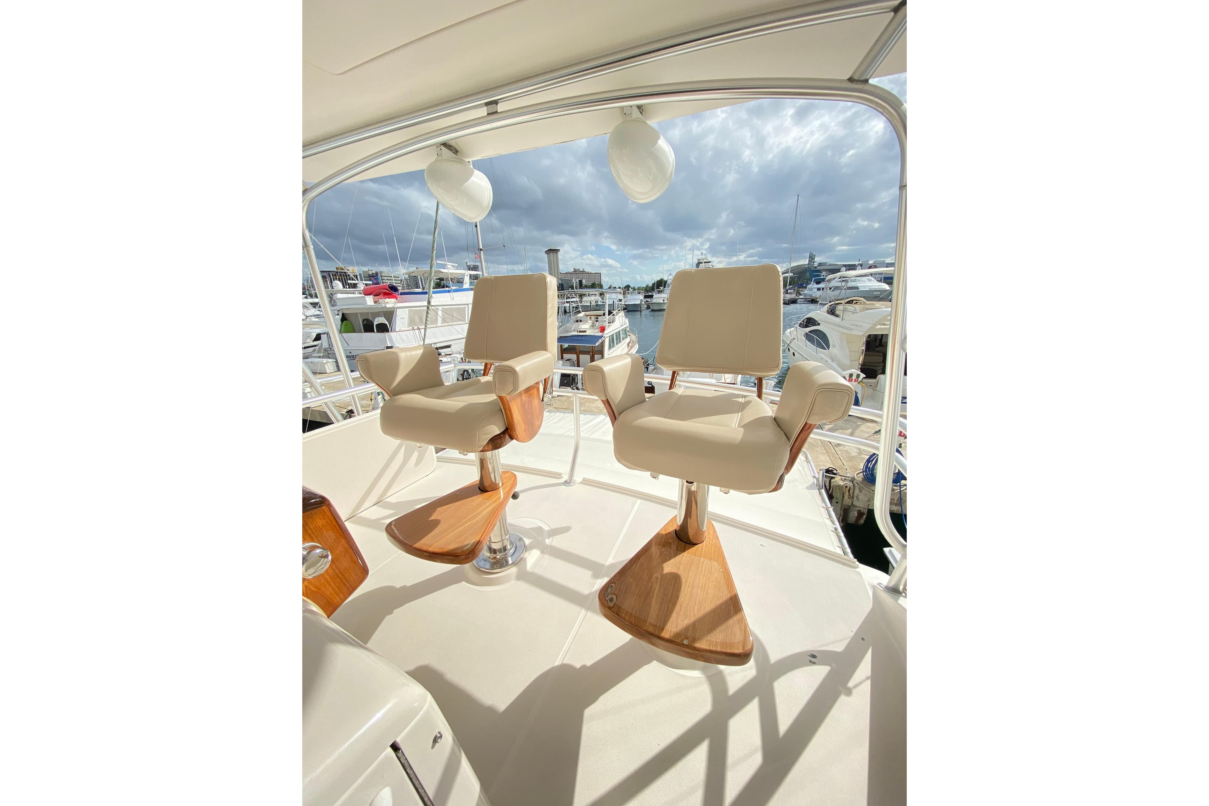 Luxury seating on 2012 Tiara Yachts 4800 Convertible, overlooking marina.