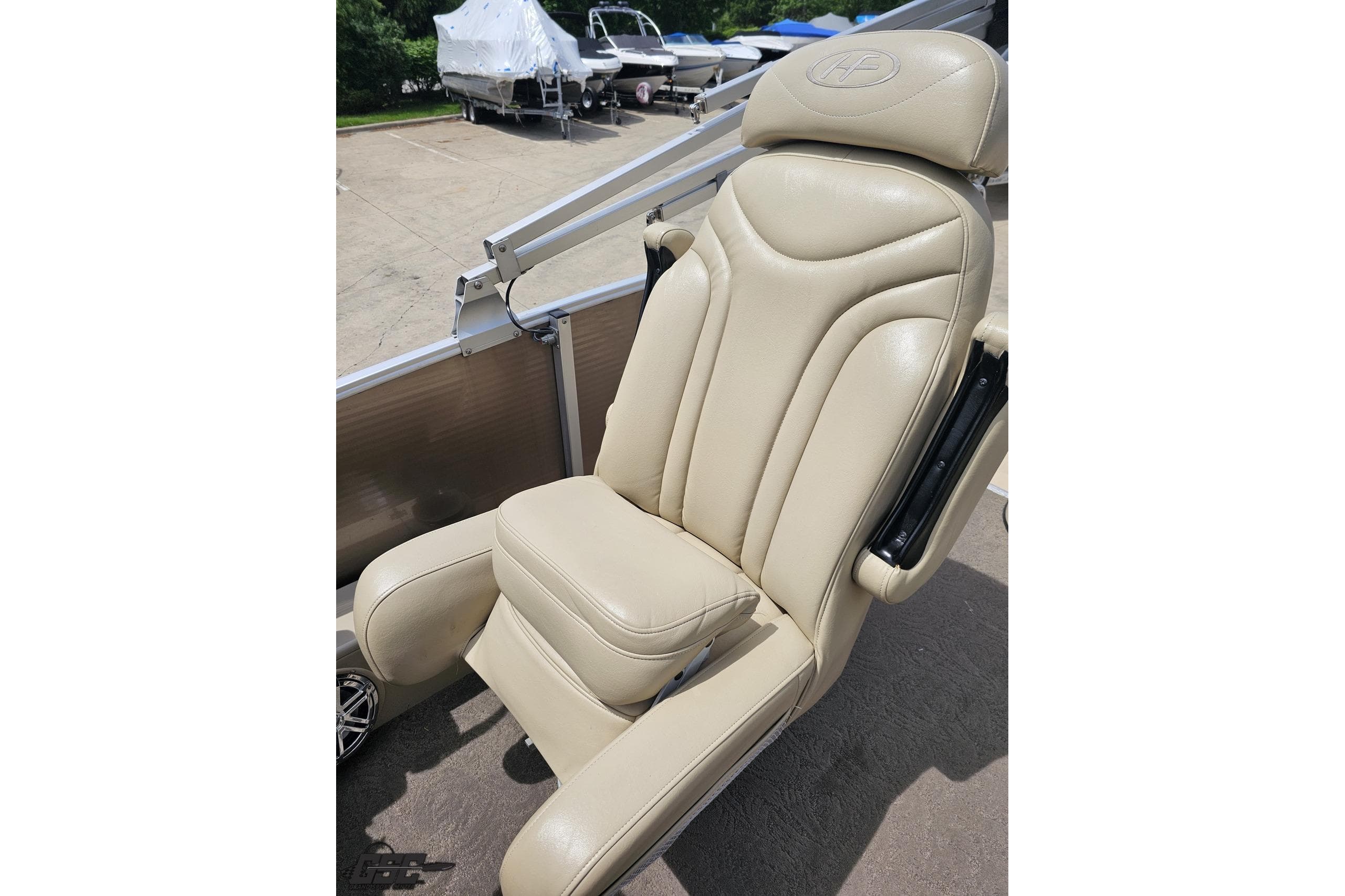 Beige captain's chair on 2012 Harris FloteBote 230 Grand Mariner SEL pontoon boat.