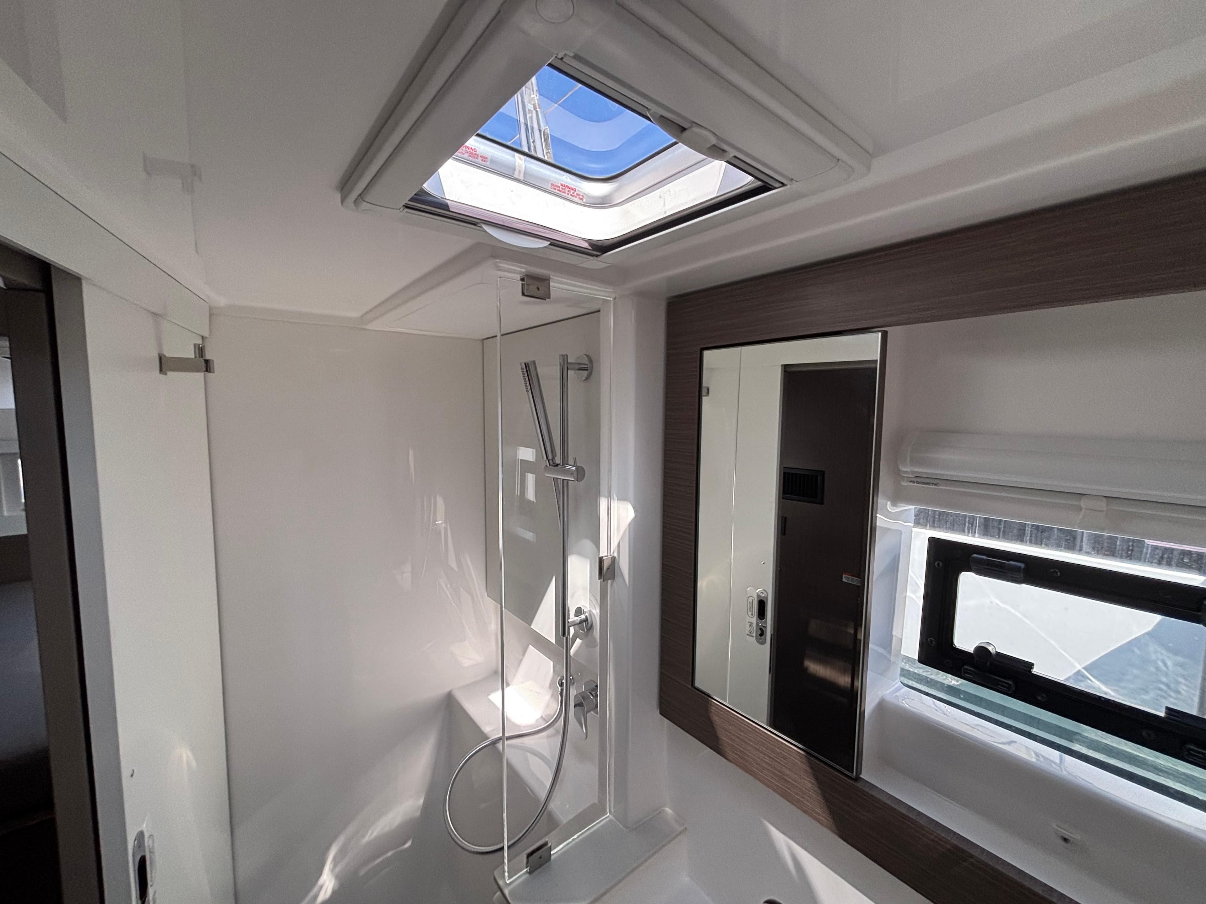 Modern bathroom interior in 2025 Leopard 42 yacht, featuring skylight and sleek shower design.