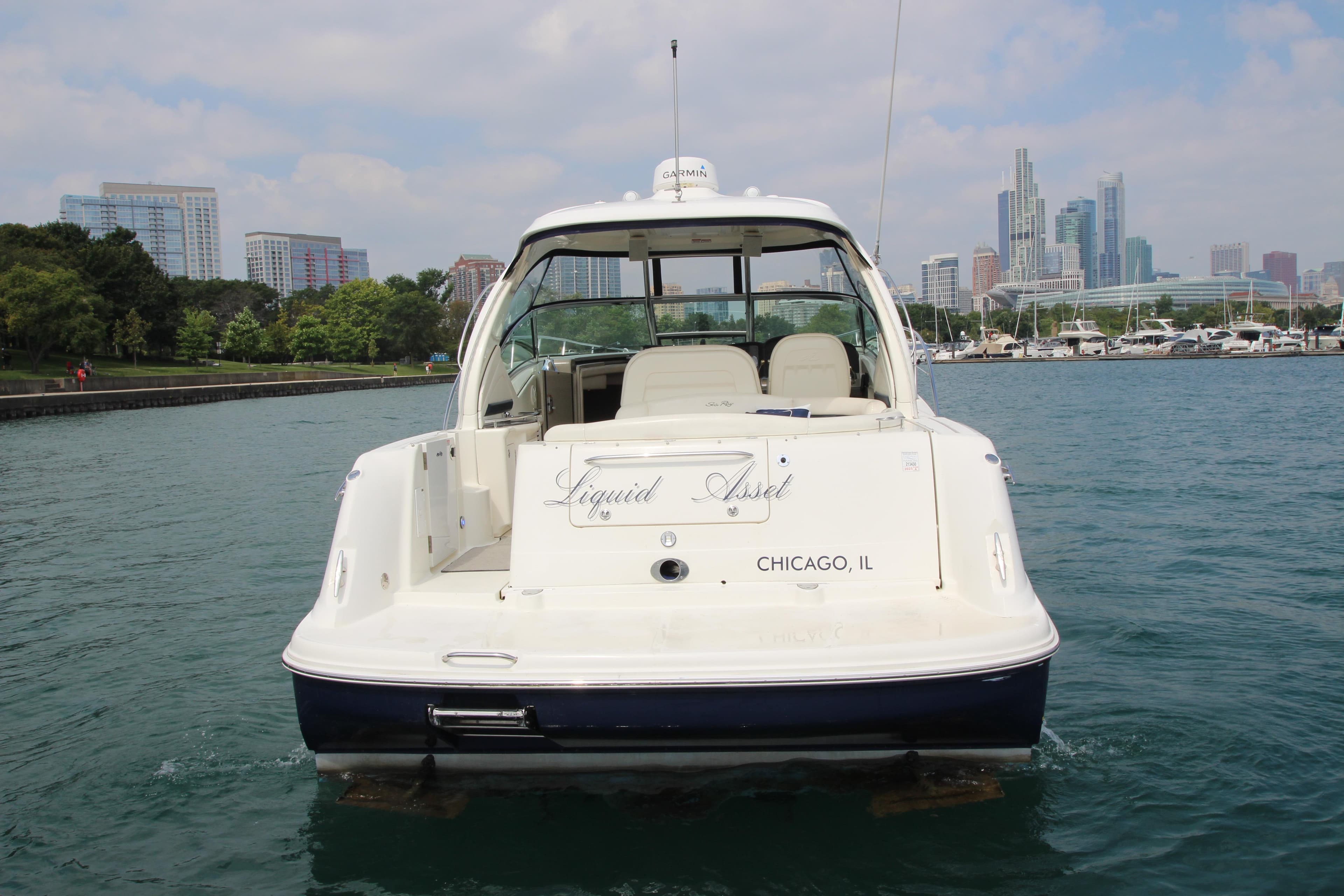 2004 Sea Ray 40 Sundancer yacht on water, Chicago skyline in background.
