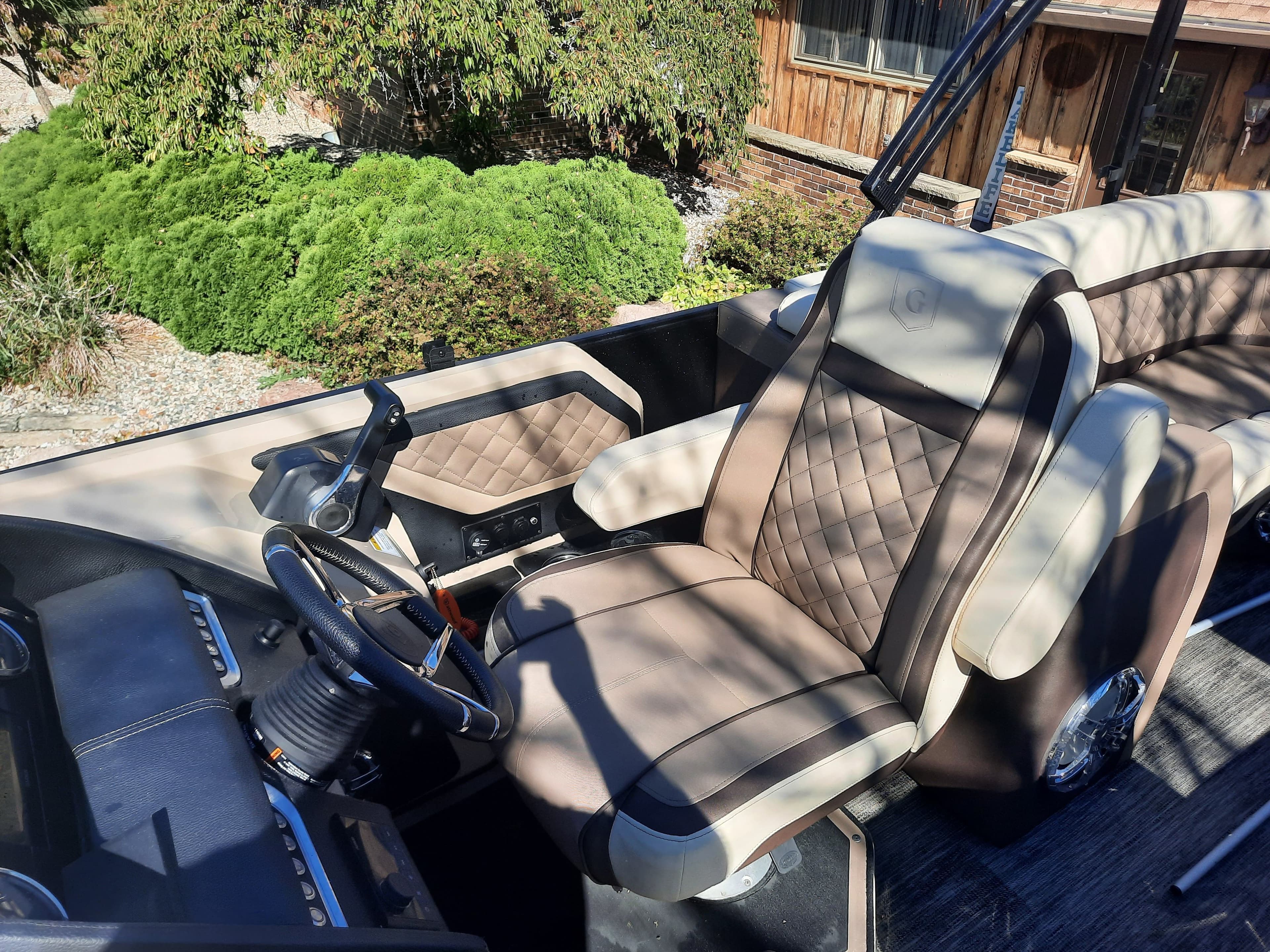 Interior of a 2022 Godfrey 23ft Tritoon boat with luxurious seating.