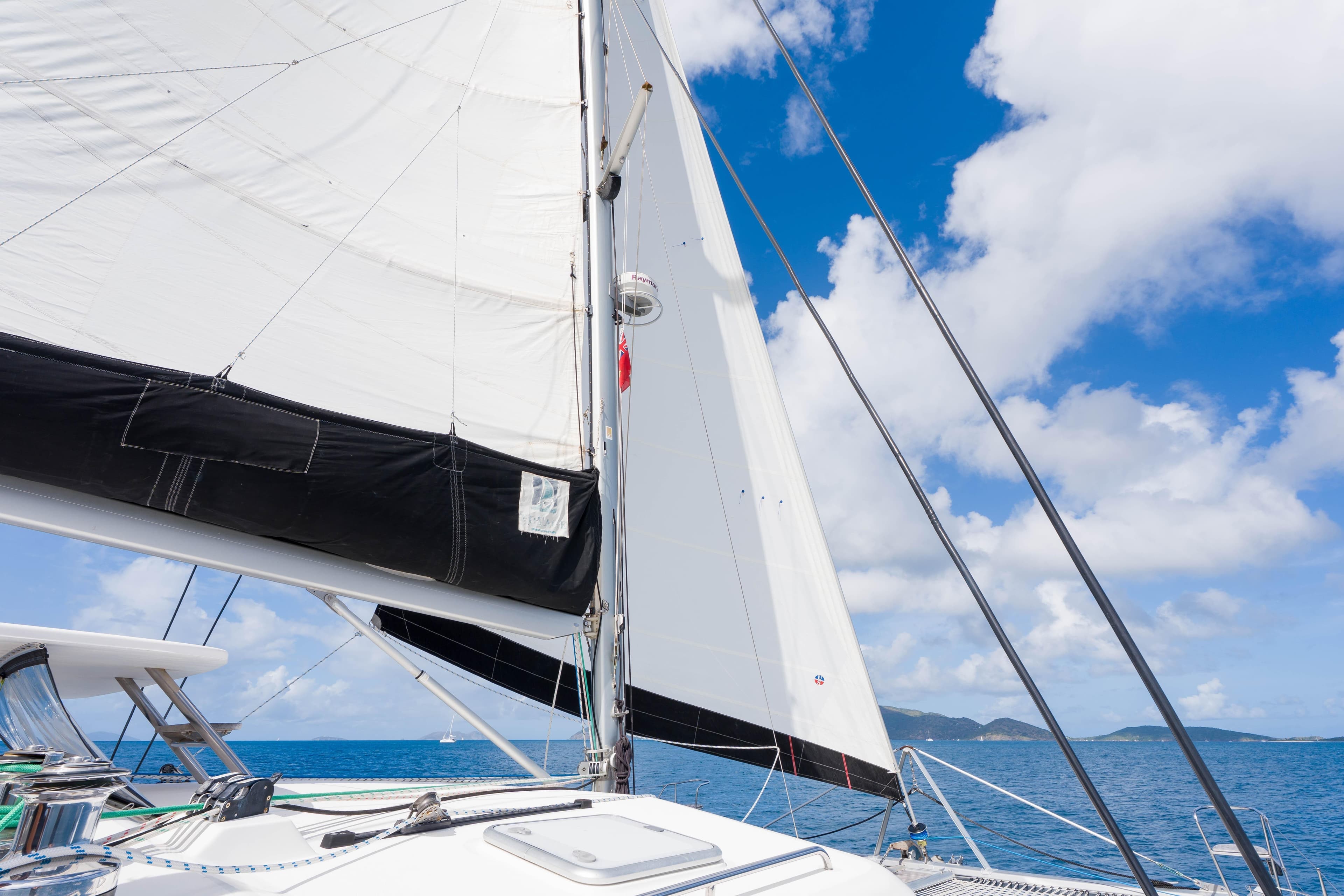 Sailing on a 2011 Voyage Yachts 520 catamaran under clear blue skies.