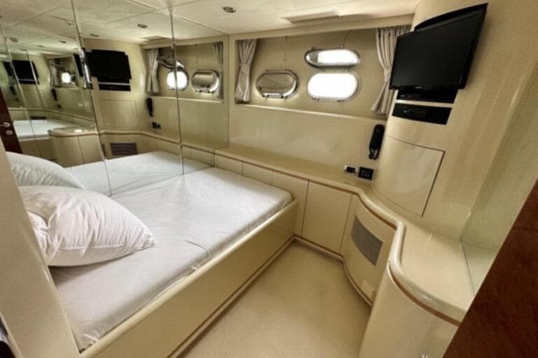 Luxurious bedroom interior of 2002 Horizon 105 yacht with mirrored walls and modern amenities.
