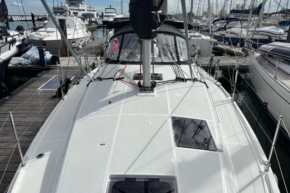 2023 Jeanneau Sun Odyssey 380 sailboat docked at marina, showcasing sleek deck design.