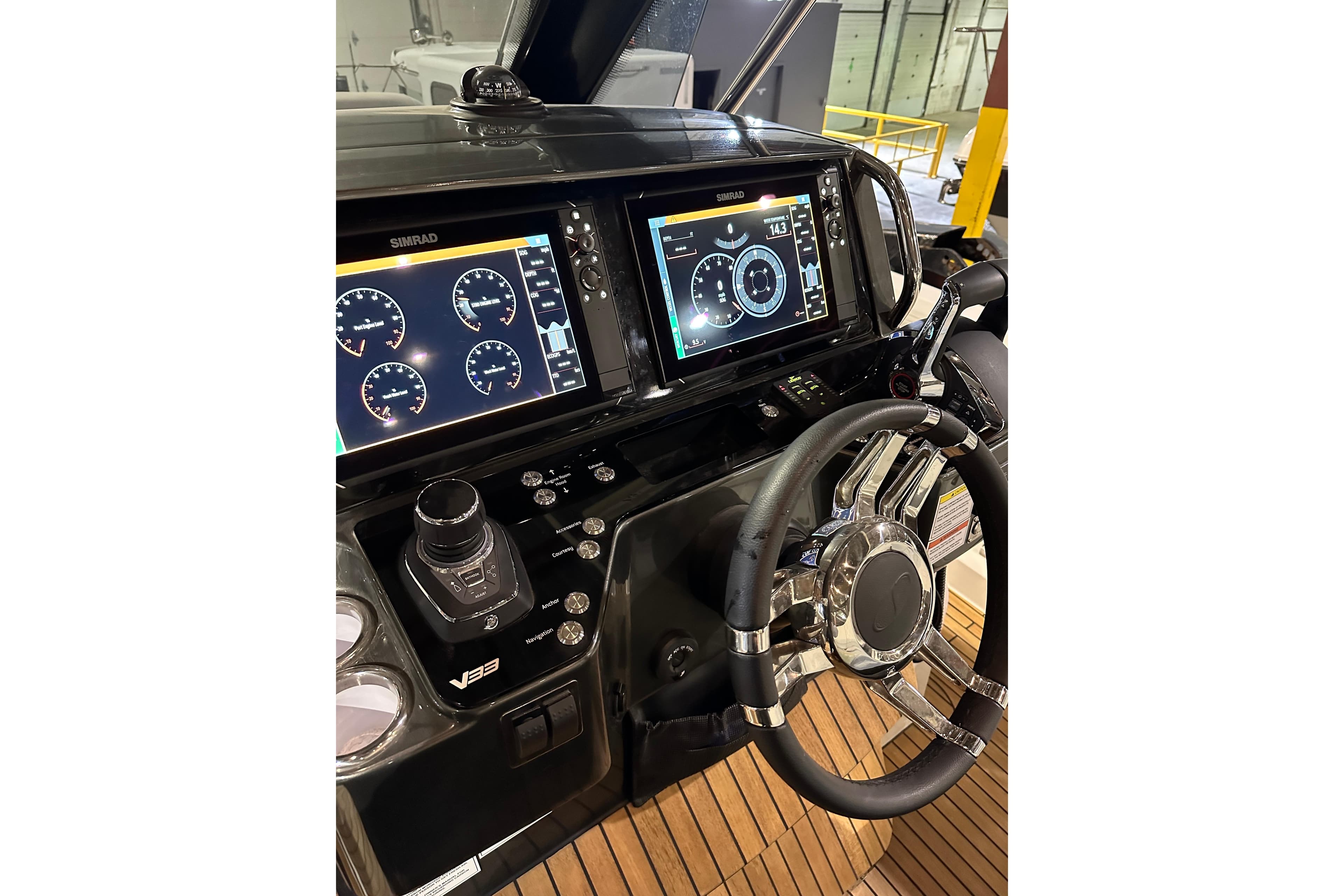 2024 Schaefer V33 yacht dashboard with Simrad displays and modern steering wheel.