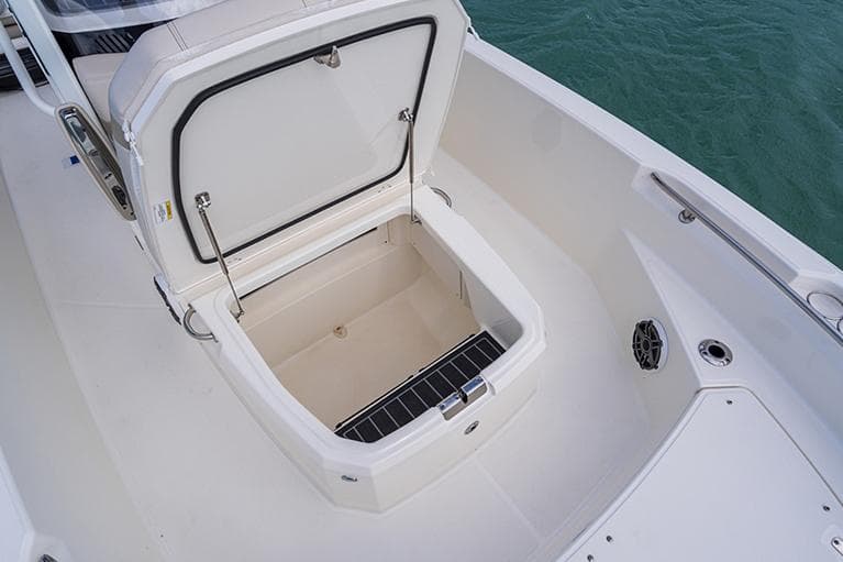 Manufacturer Provided Image: 2026 Boston Whaler 220 Dauntless boat storage compartment open on deck.