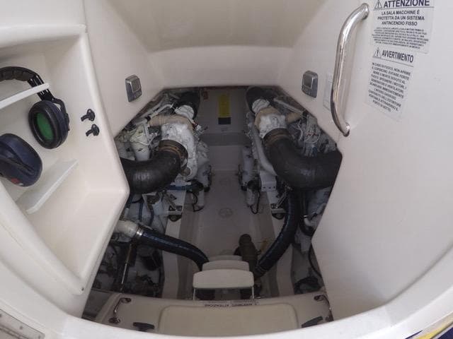Engine room of a 2007 Cabo 43 FB boat, featuring dual engines and safety instructions.