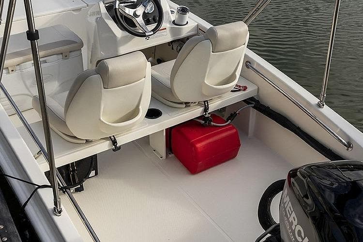 2025 Boston Whaler 130 Super Sport interior with dual seats and Mercury engine.