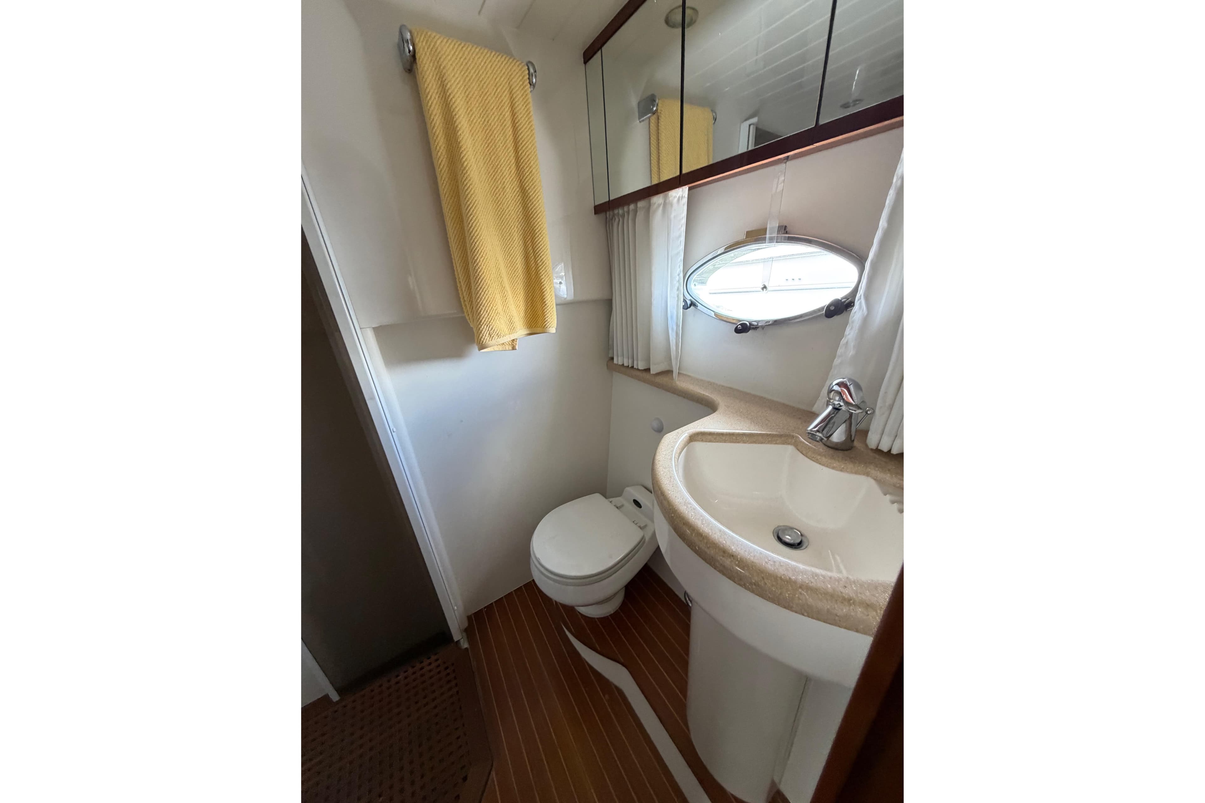 Bathroom interior of 2003 Viking Princess V50 yacht with sink, toilet, and mirror.