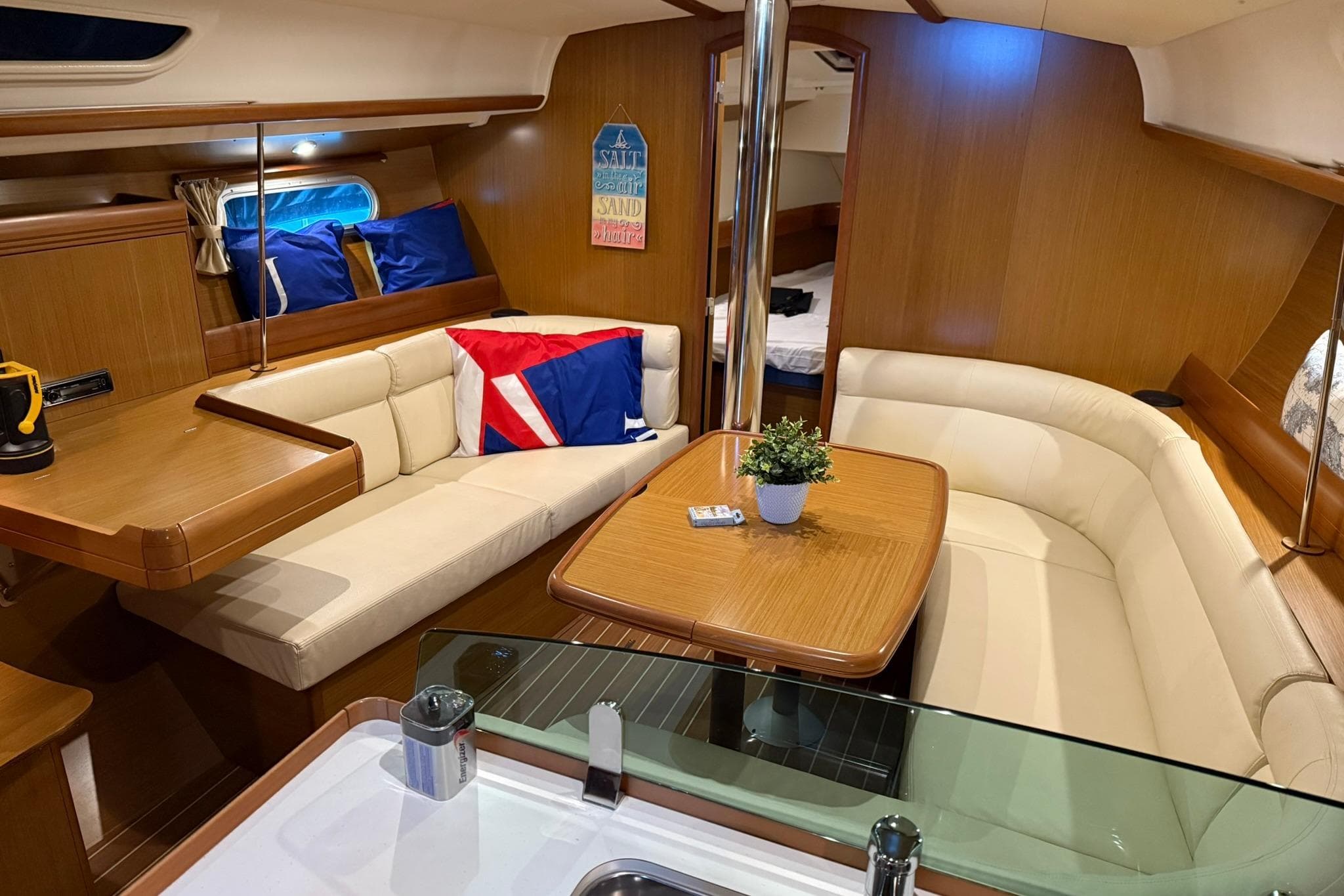 Luxurious interior of 2007 Jeanneau Sun Odyssey 39i sailboat with cozy seating and elegant decor.