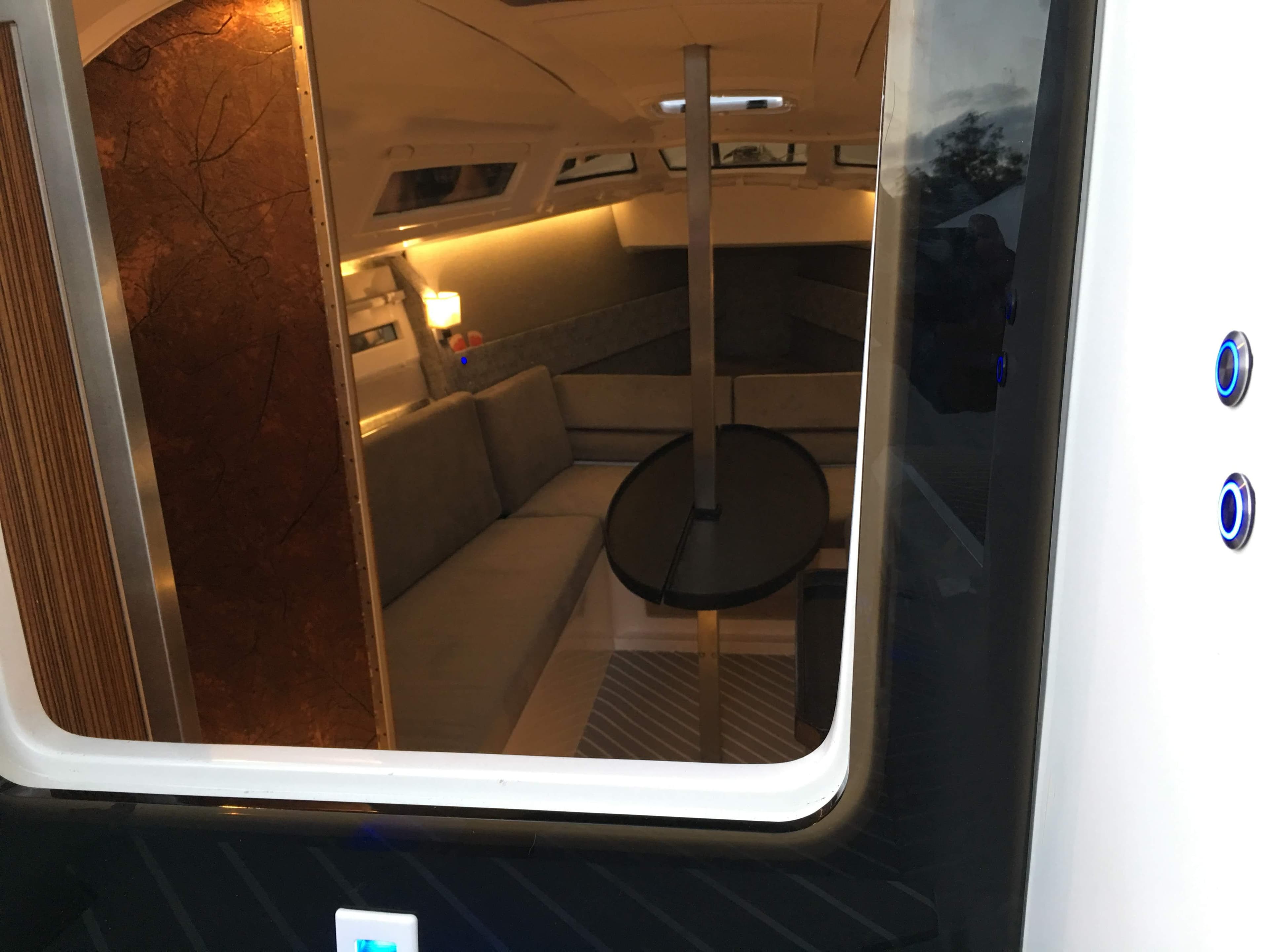Interior view of 2025 Faro Yachts 29, featuring modern seating and ambient lighting.