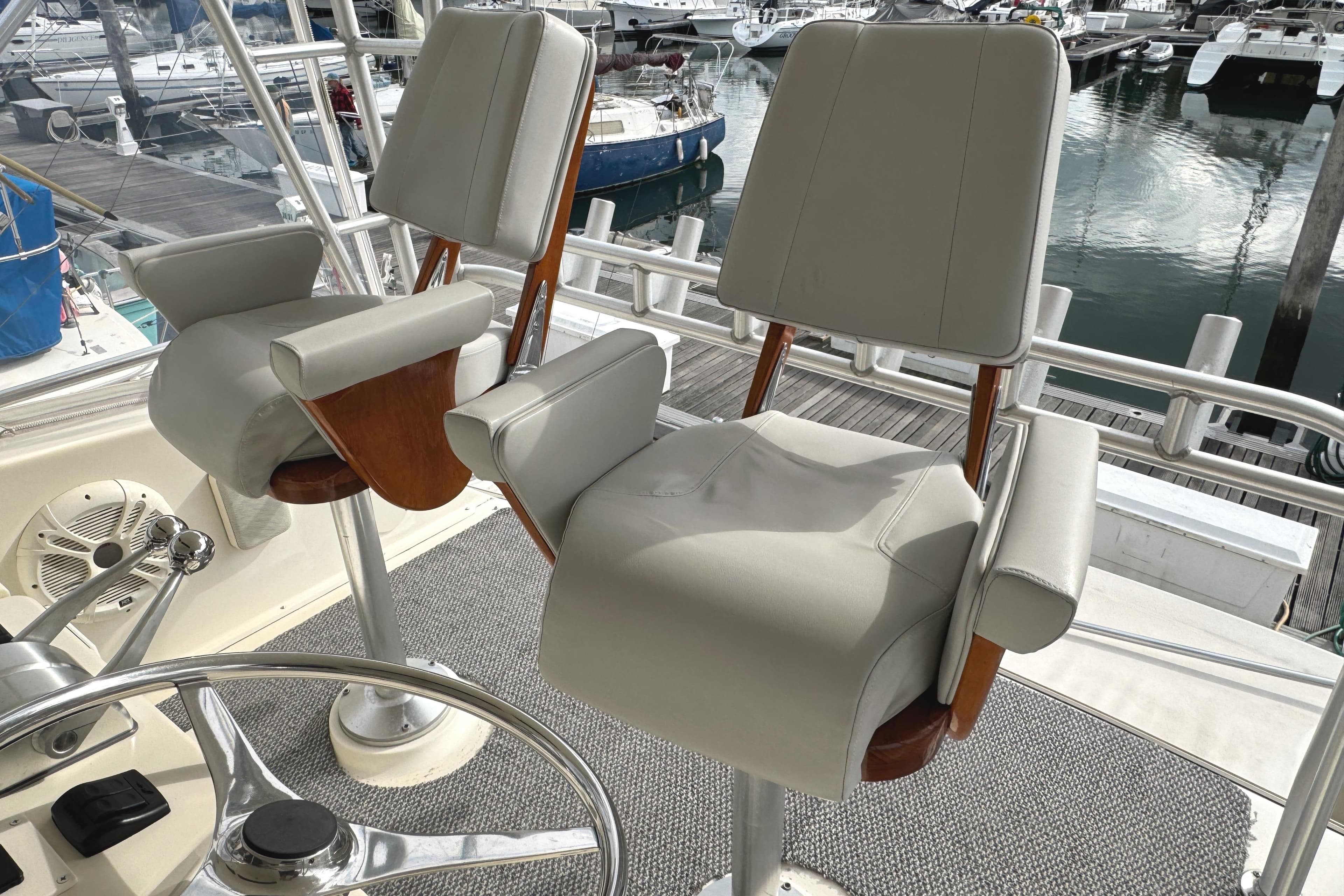 Captain's chairs on 1991 Viking 53 Convertible yacht, docked at marina.