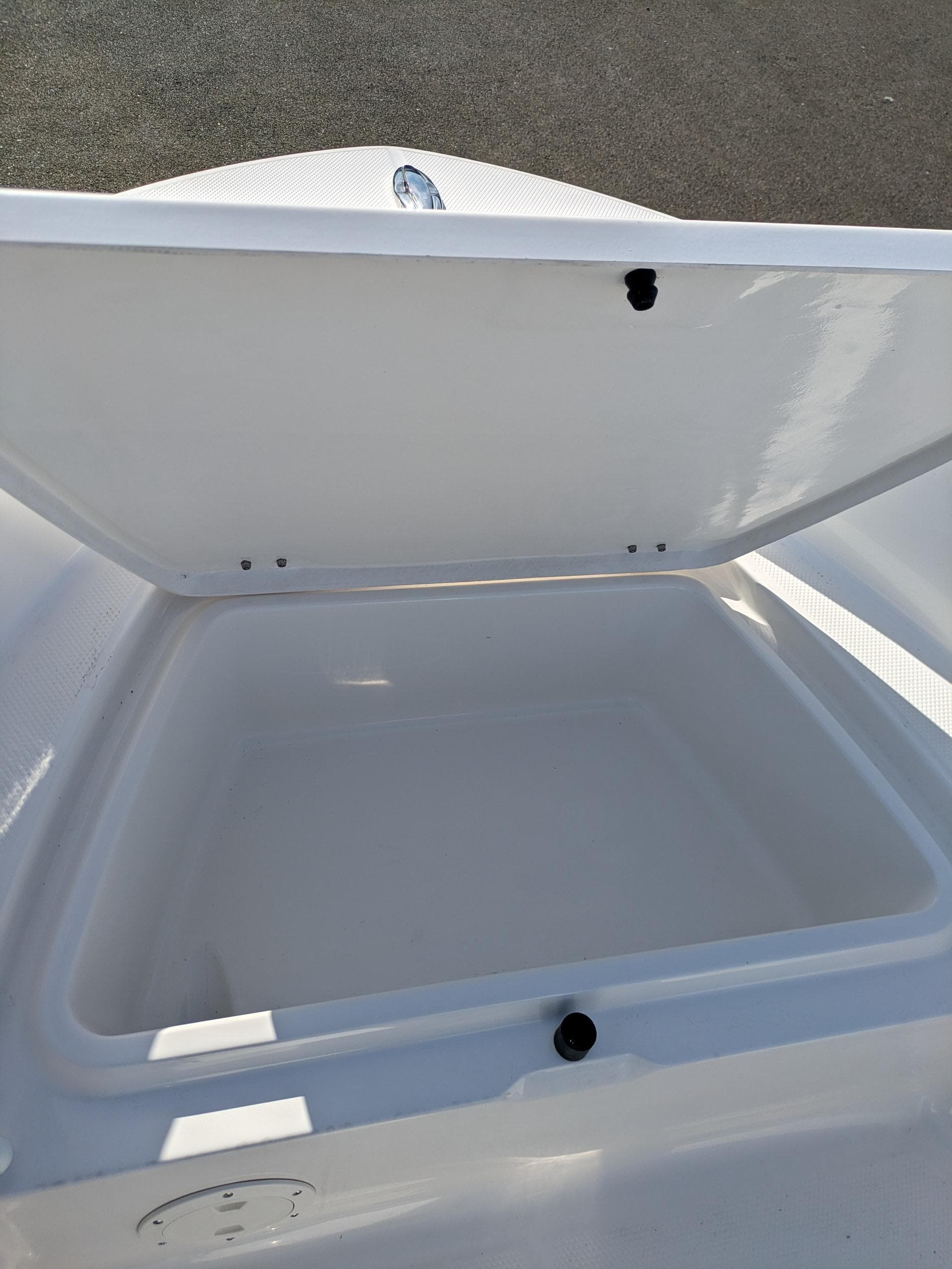 2025 Robalo R160 boat storage compartment open, showcasing spacious interior design.