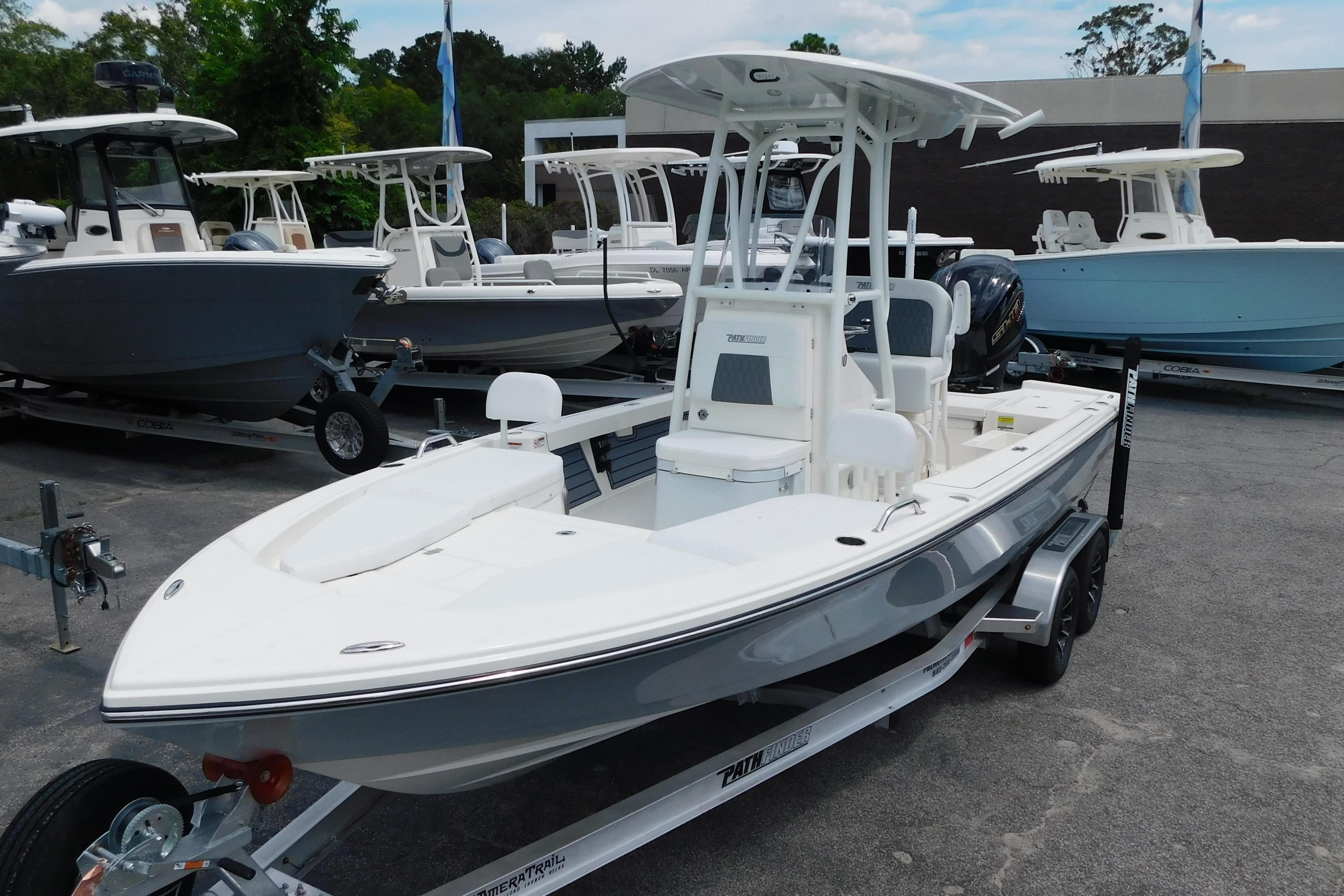 2026 Pathfinder 2200 TRS boat on trailer, displayed at dealership with other boats.