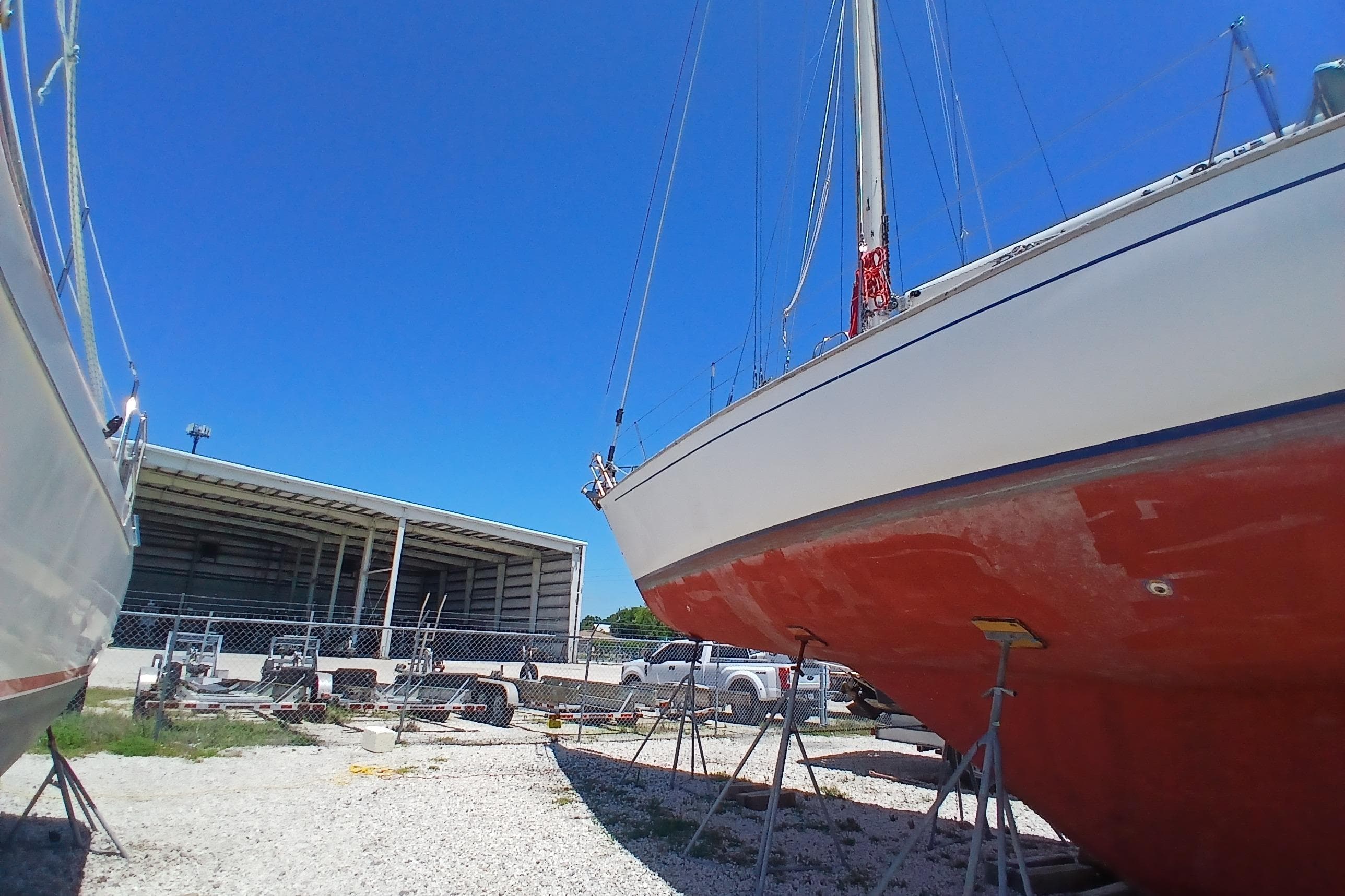 1981 Kaufman Skye 51 sailboat on stands, blue sky background.