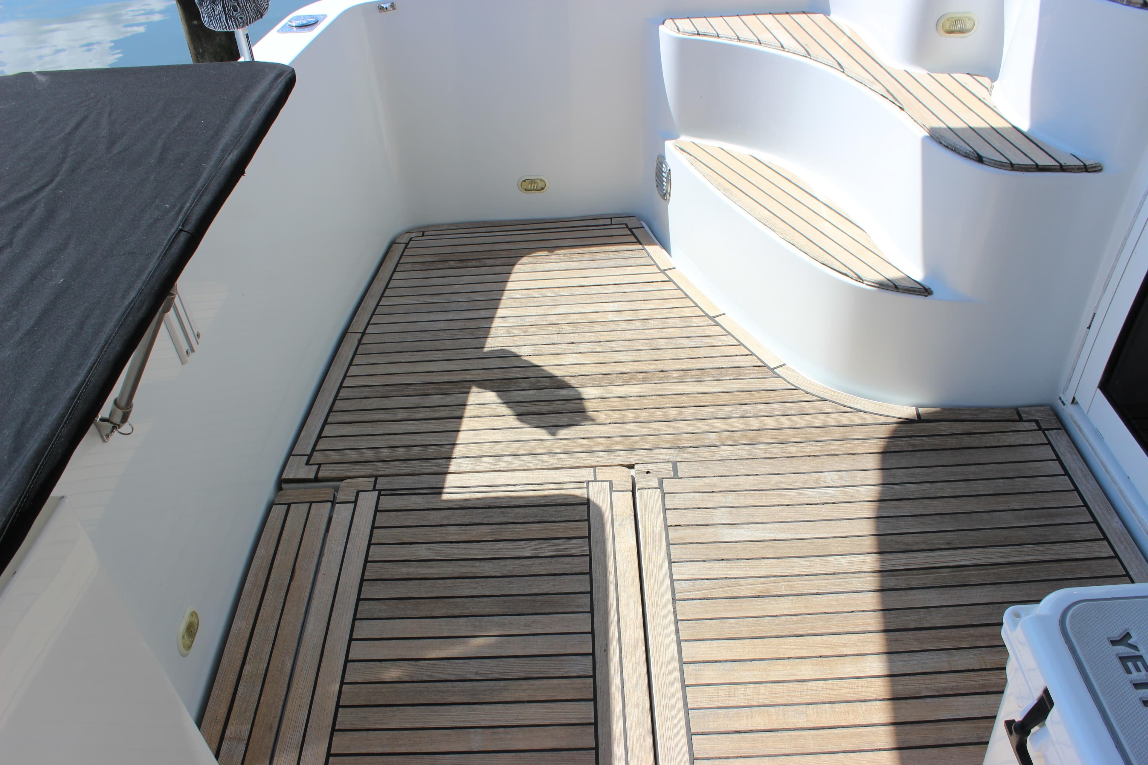 2003 Carver 36 Super Sport yacht deck with wooden flooring and steps.