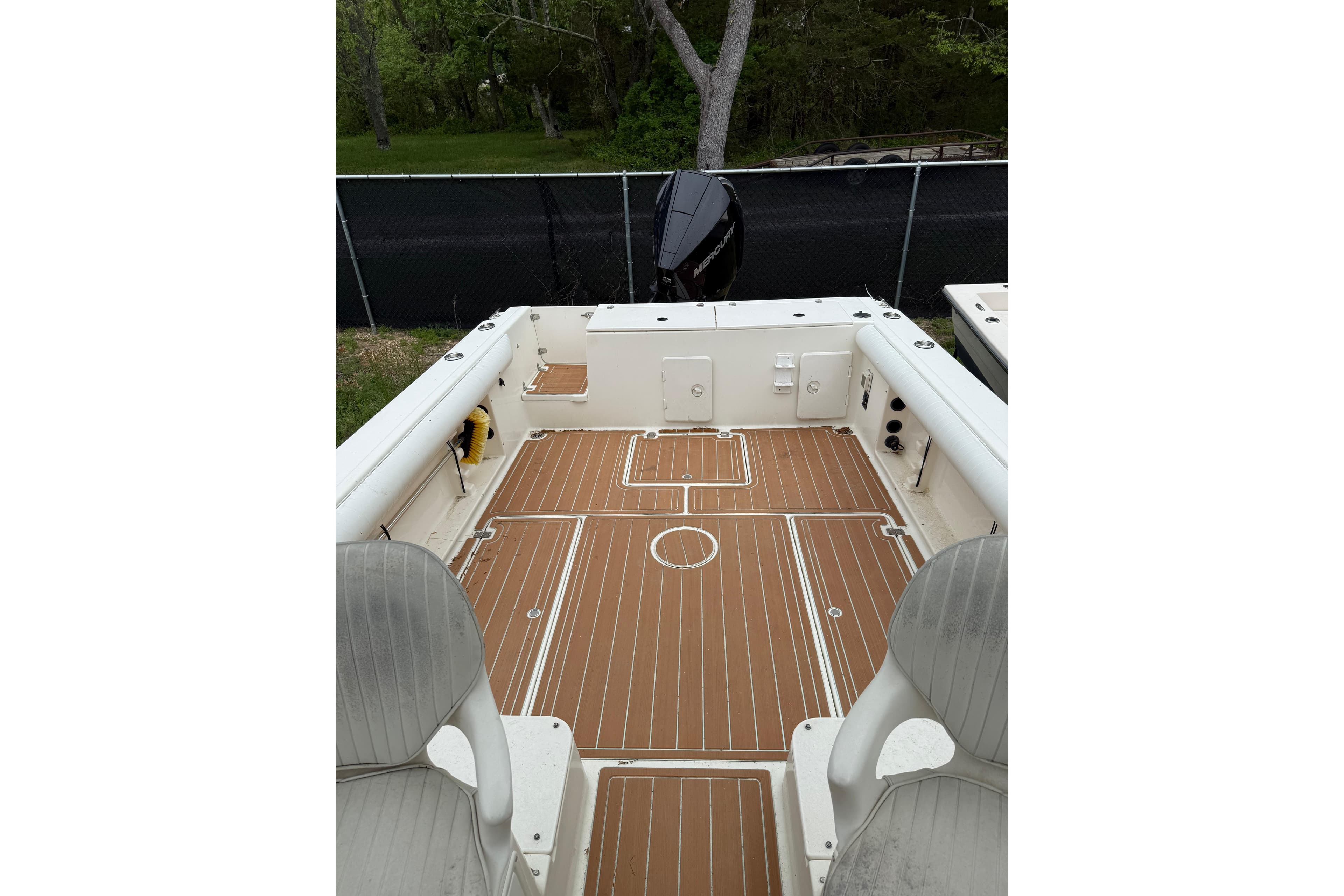 2002 Sports-Craft 261 boat interior with teak flooring and seating, docked outdoors.