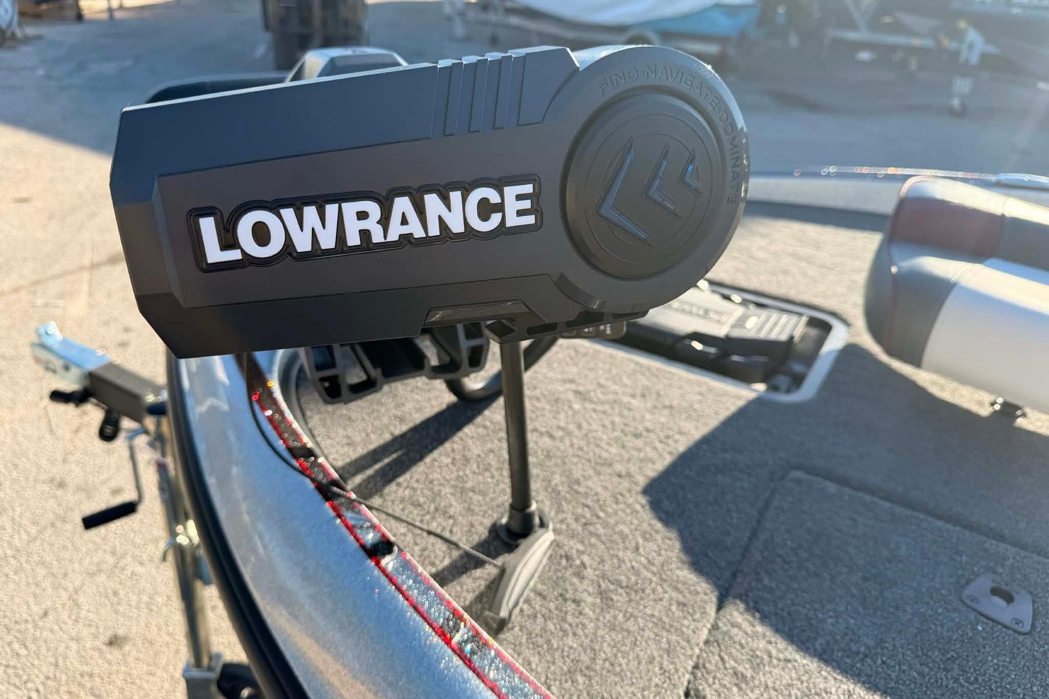 Lowrance device on 2026 Triton 179 TrX boat deck, sunny day.