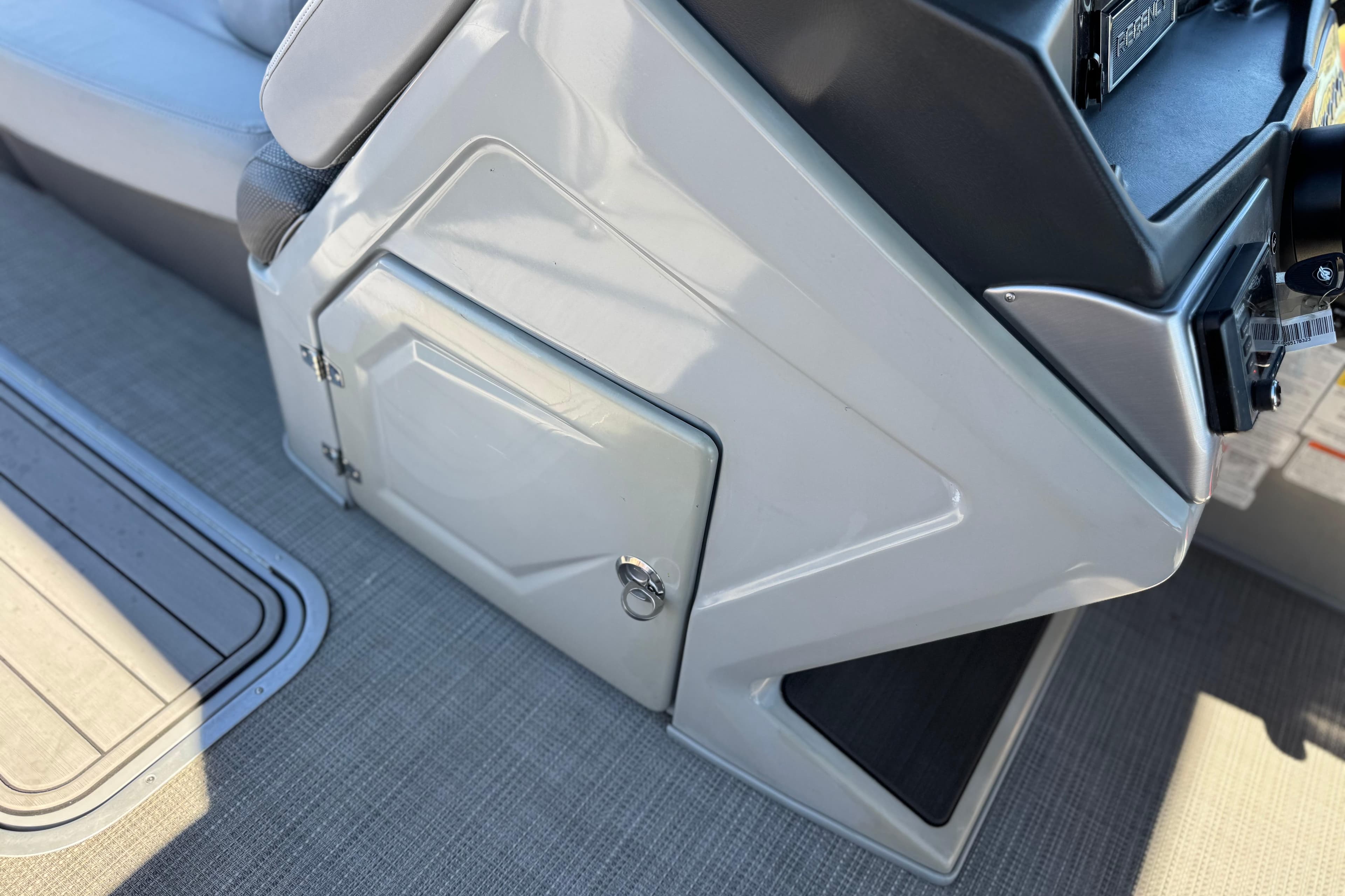 2023 Regency 250 DL3 boat console with storage compartment and seating area.