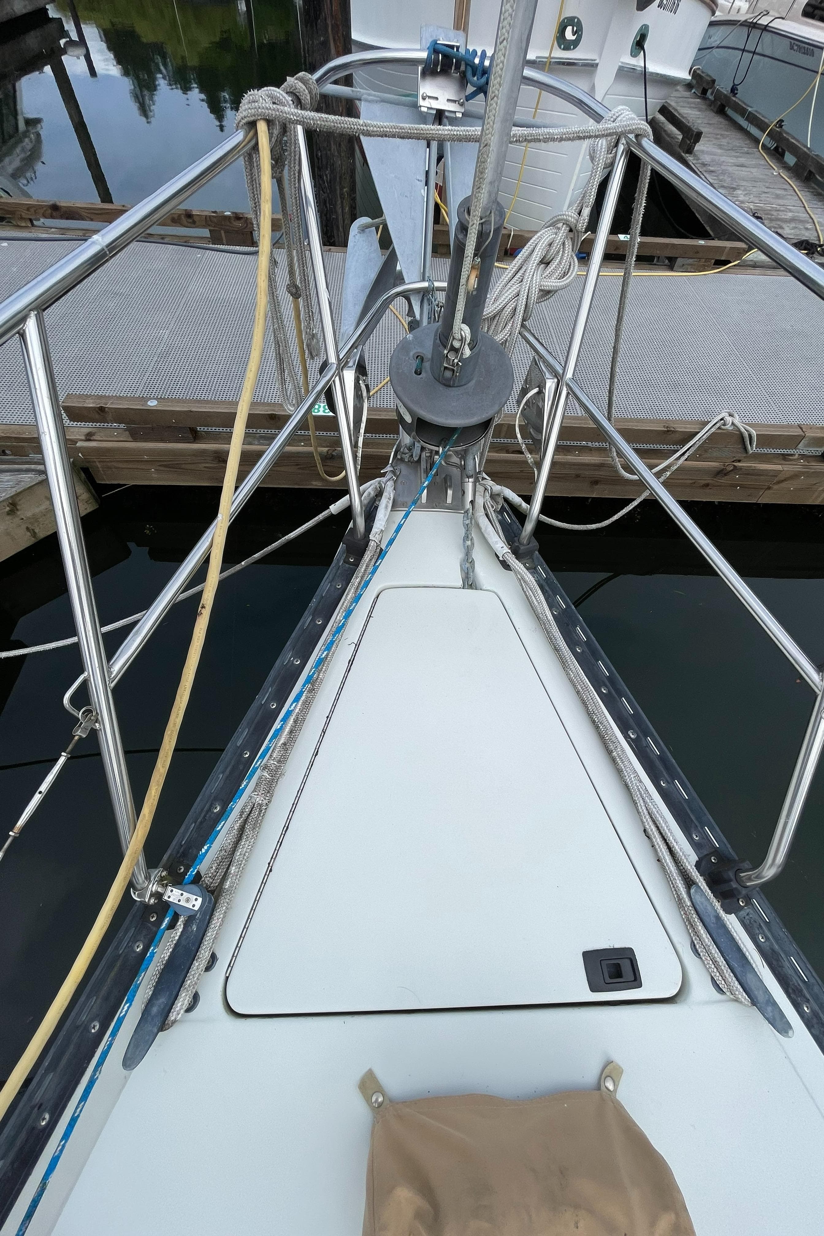 Bow of 1989 C&C 37/40+ sailboat docked, showing deck and rigging details.